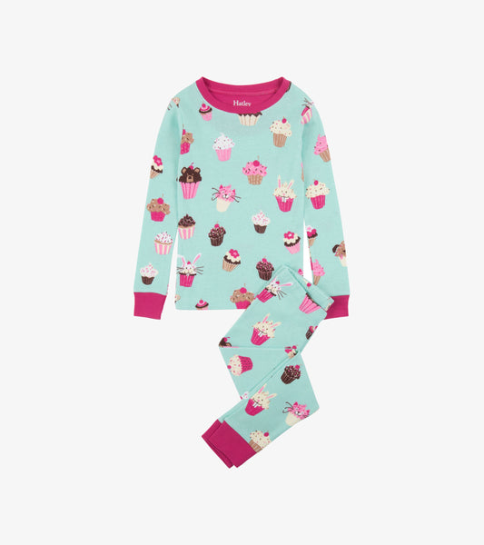 Light blue organic cotton pajama set featuring colorful cupcake patterns, with pink cuffs on the long-sleeve top and pants.