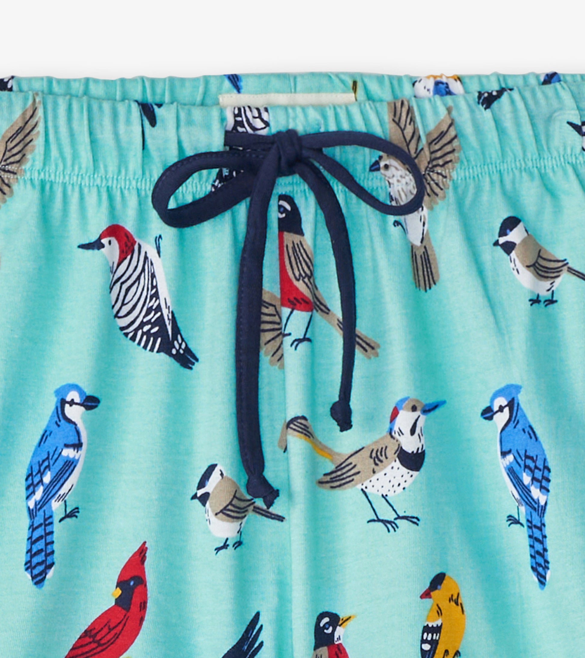 Light blue cotton sleep shorts featuring colorful bird patterns and a navy drawstring at the waist.