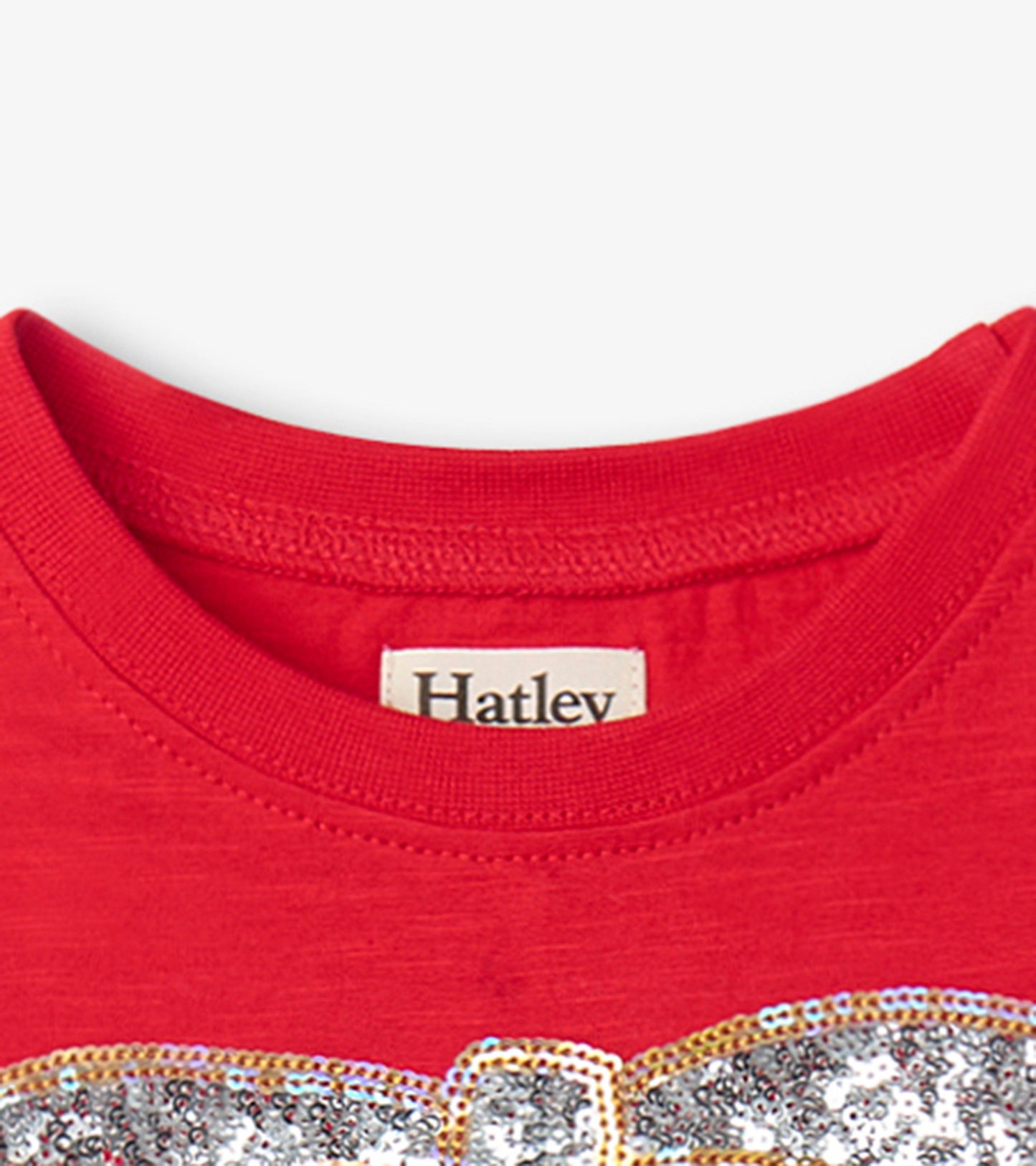 Red holiday dress featuring a sparkly bow design and a classic crew neckline.