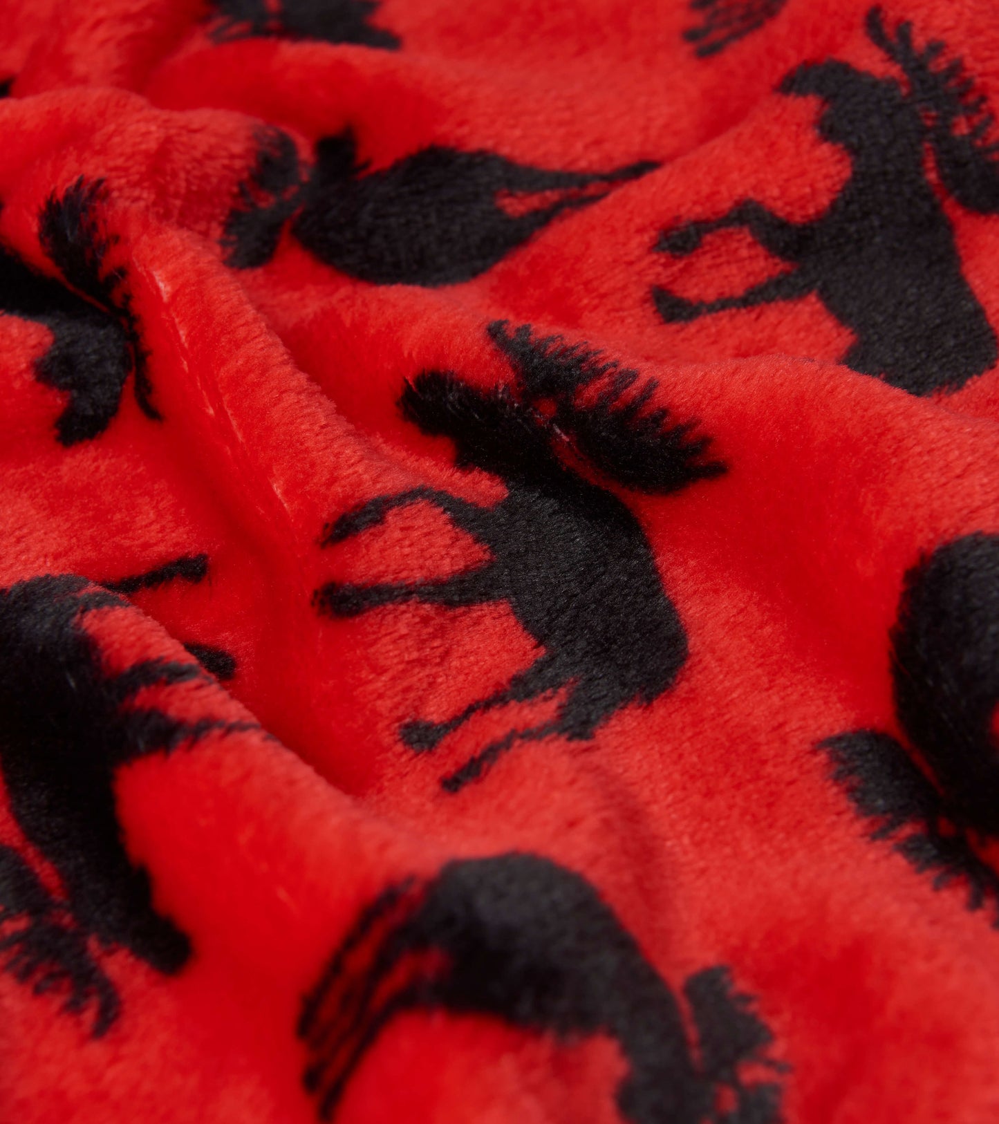 Red fleece blanket featuring a pattern of black moose silhouettes. Soft and cozy for warmth and comfort.