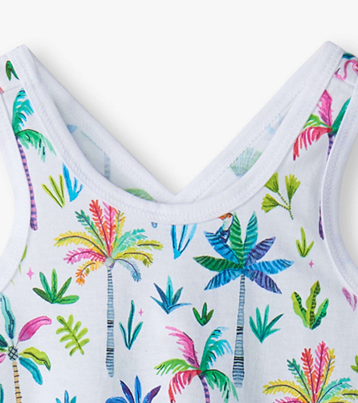 White trapeze dress featuring colorful palm tree and leaf prints, ideal for warm weather wear.