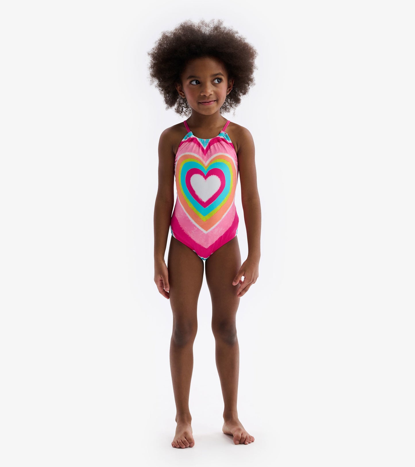 Psychedelic heart-patterned swimsuit in vibrant pink, featuring a gathered front and adjustable straps.