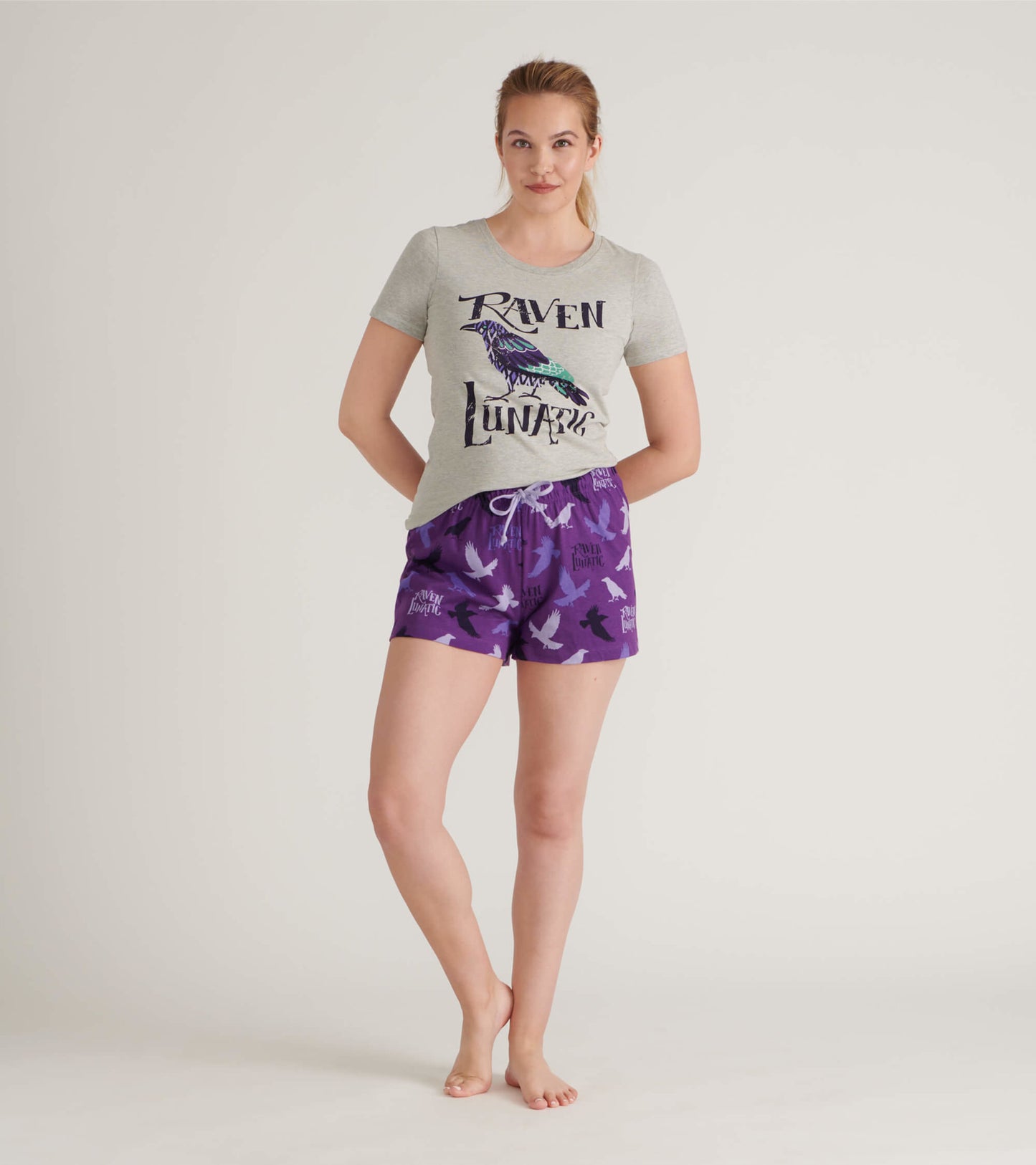 Purple cotton sleep shorts featuring a bird pattern and an elastic waistband with drawstring.
