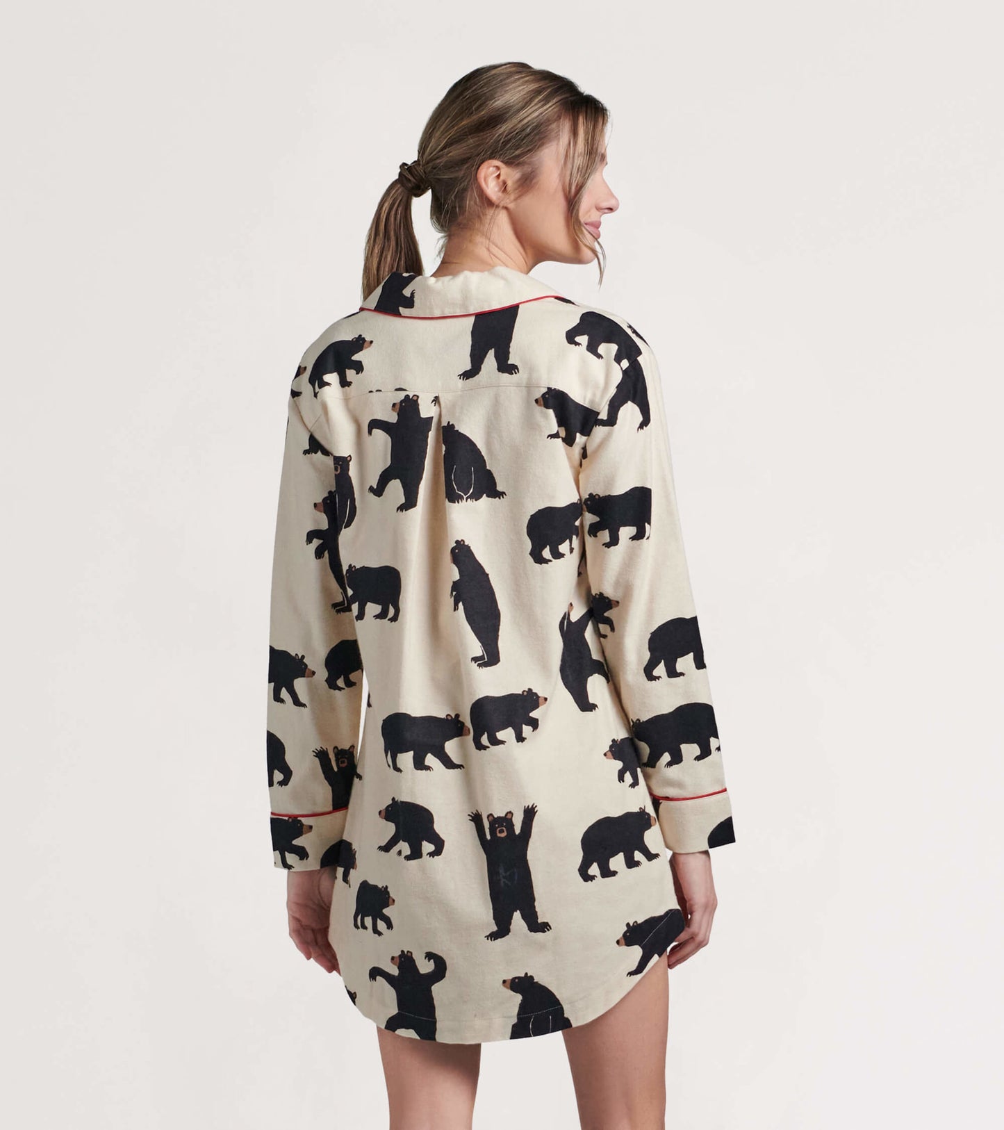 Black flannel nightgown featuring a playful bear pattern, long sleeves, and a relaxed fit, shown from the back.