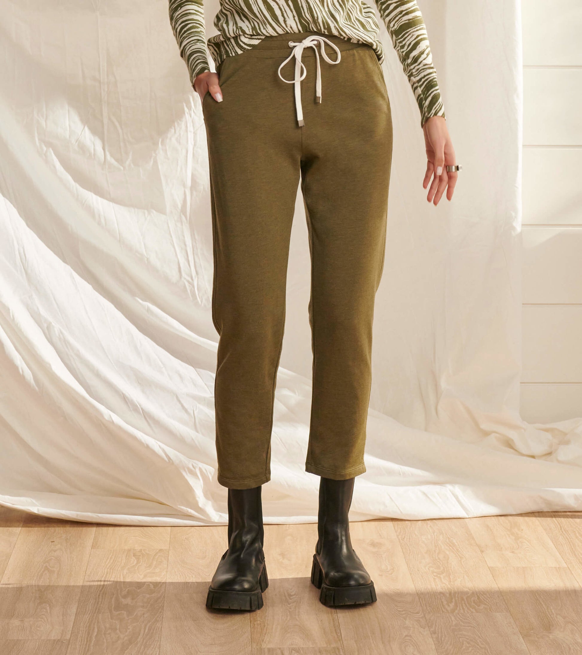 Loden green melange joggers with a drawstring waist, tapered legs, and side pockets, styled with a patterned top.