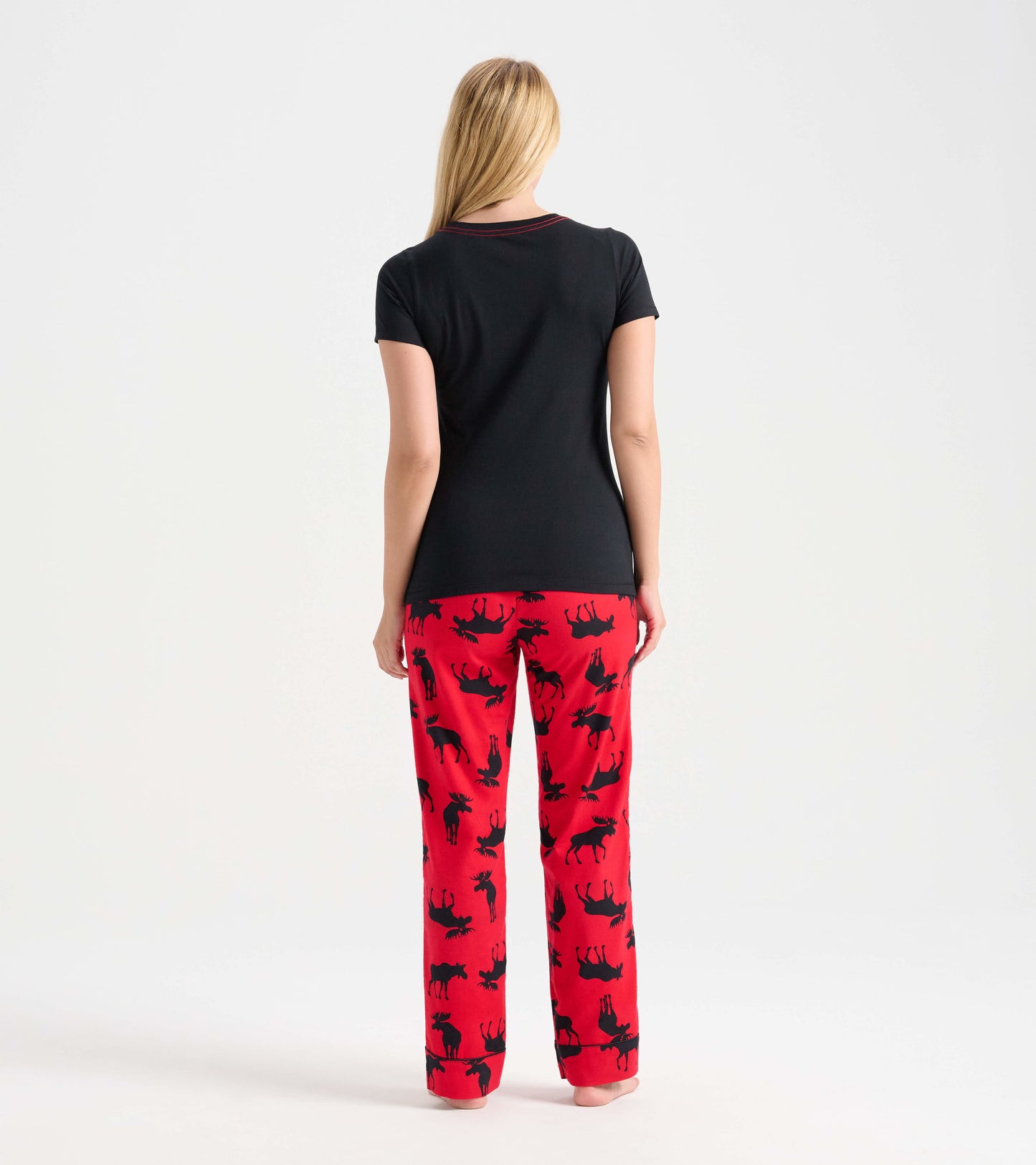 Black short-sleeve pajama t-shirt paired with red pants featuring a moose pattern, viewed from the back.