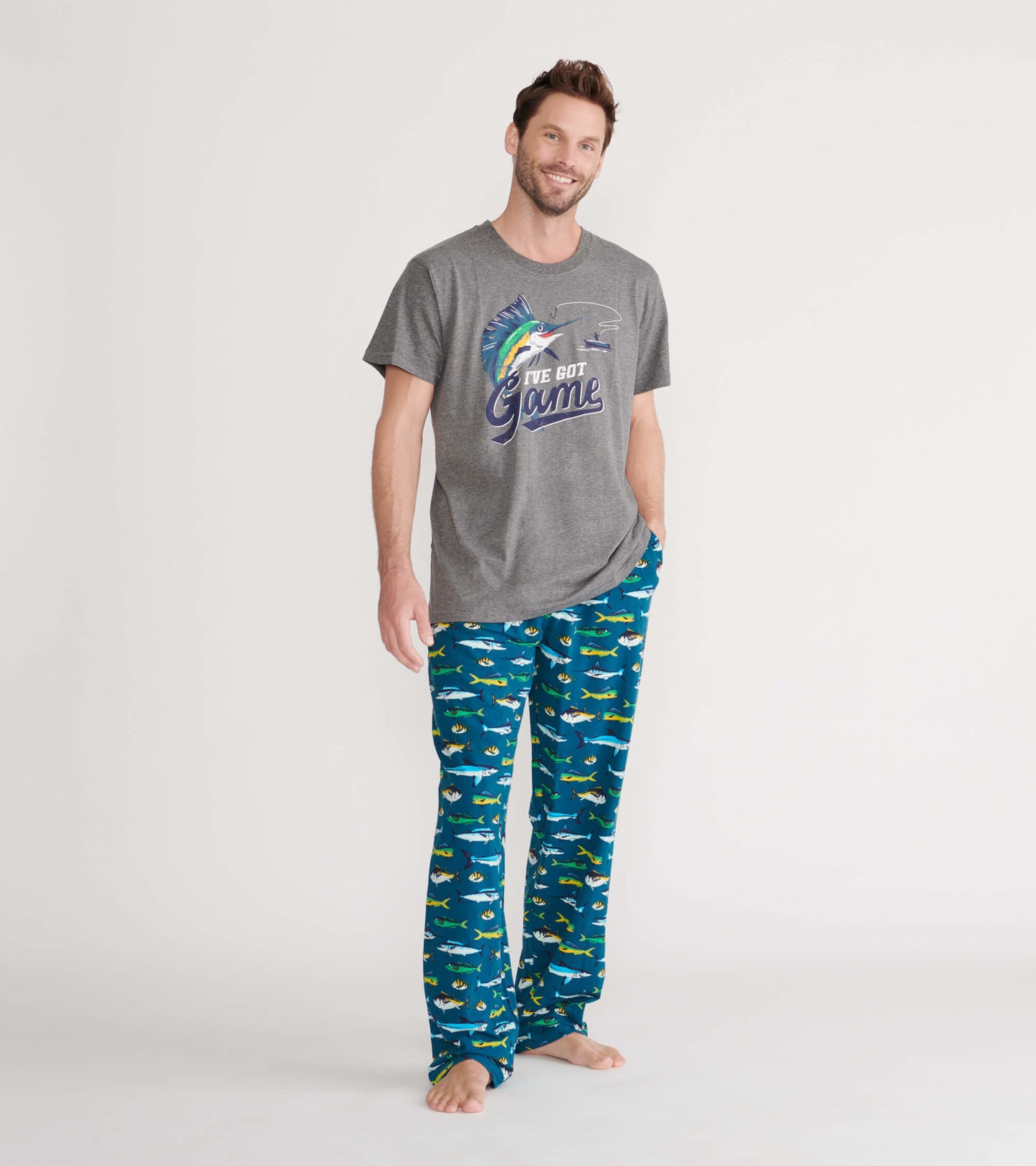 Gray short-sleeve tee with a colorful fish graphic, paired with blue pajama pants featuring various fish patterns.