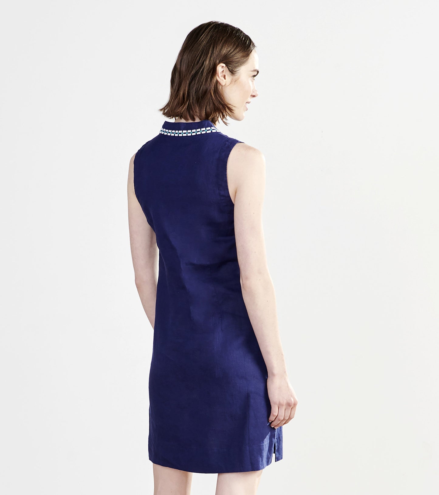 Sleeveless patriot blue dress with a collar and side slits, shown from the back.