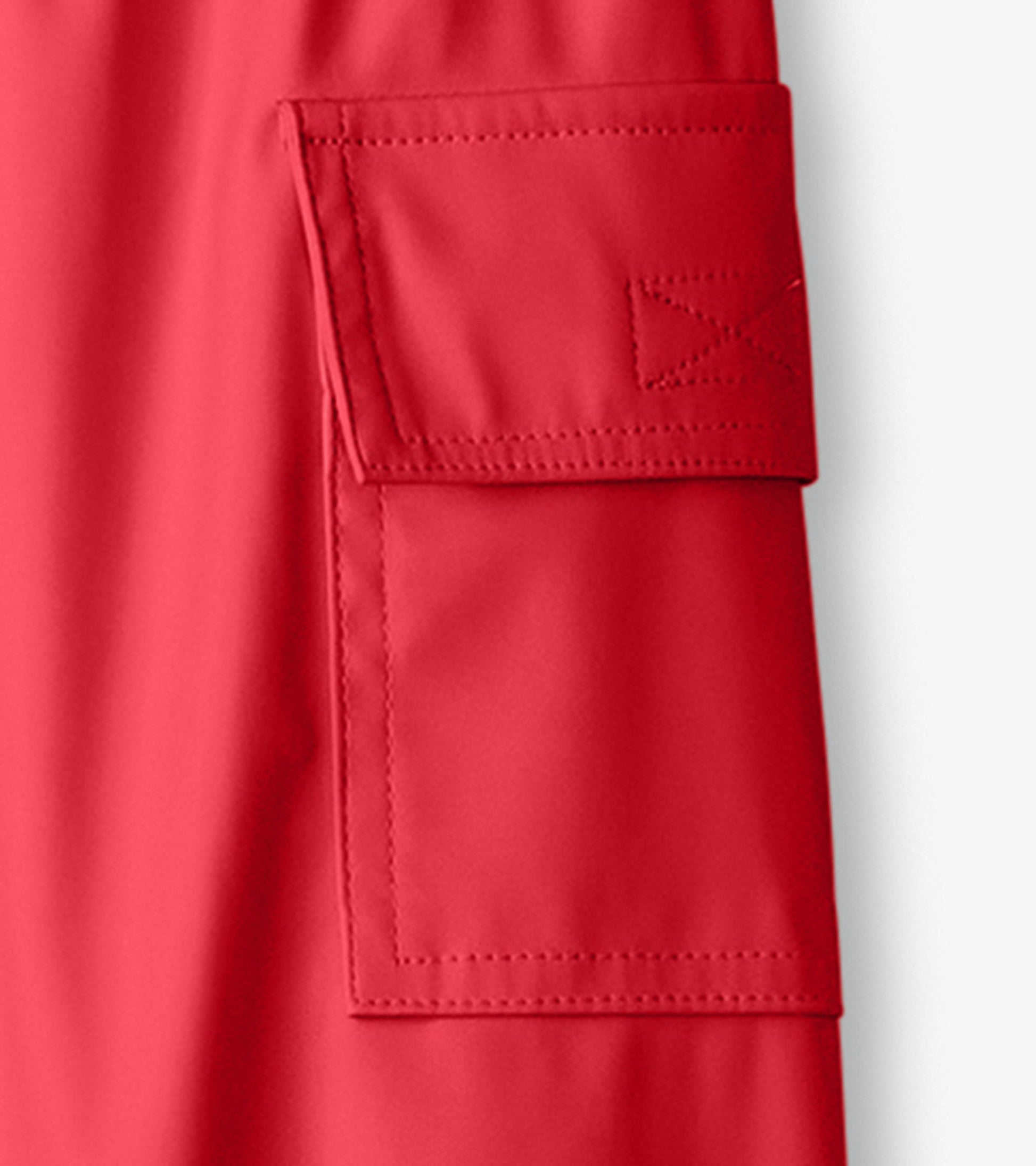 Red waterproof kids' rain pants featuring a side pocket and smooth finish, ideal for outdoor play in wet weather.