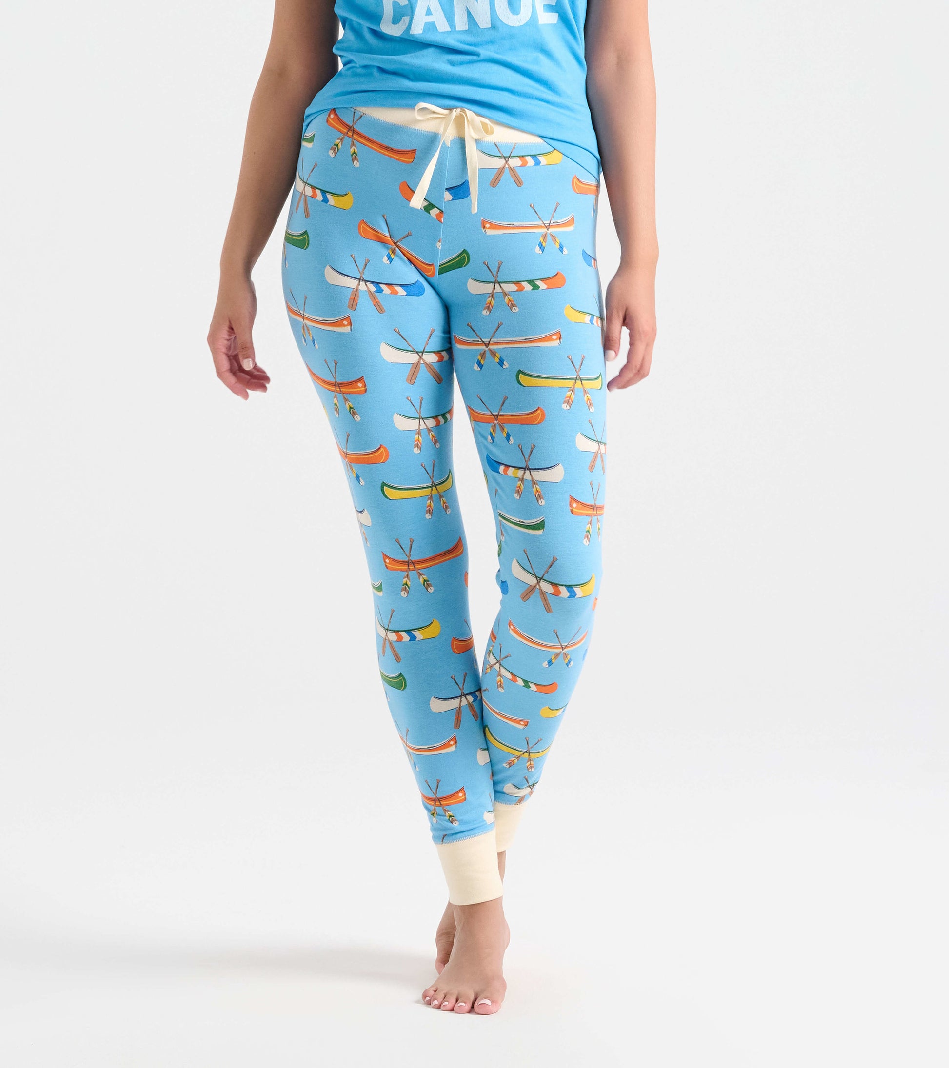 Light blue sleep leggings featuring a colorful canoe and paddle pattern, with a fitted design and cuffed ankles.
