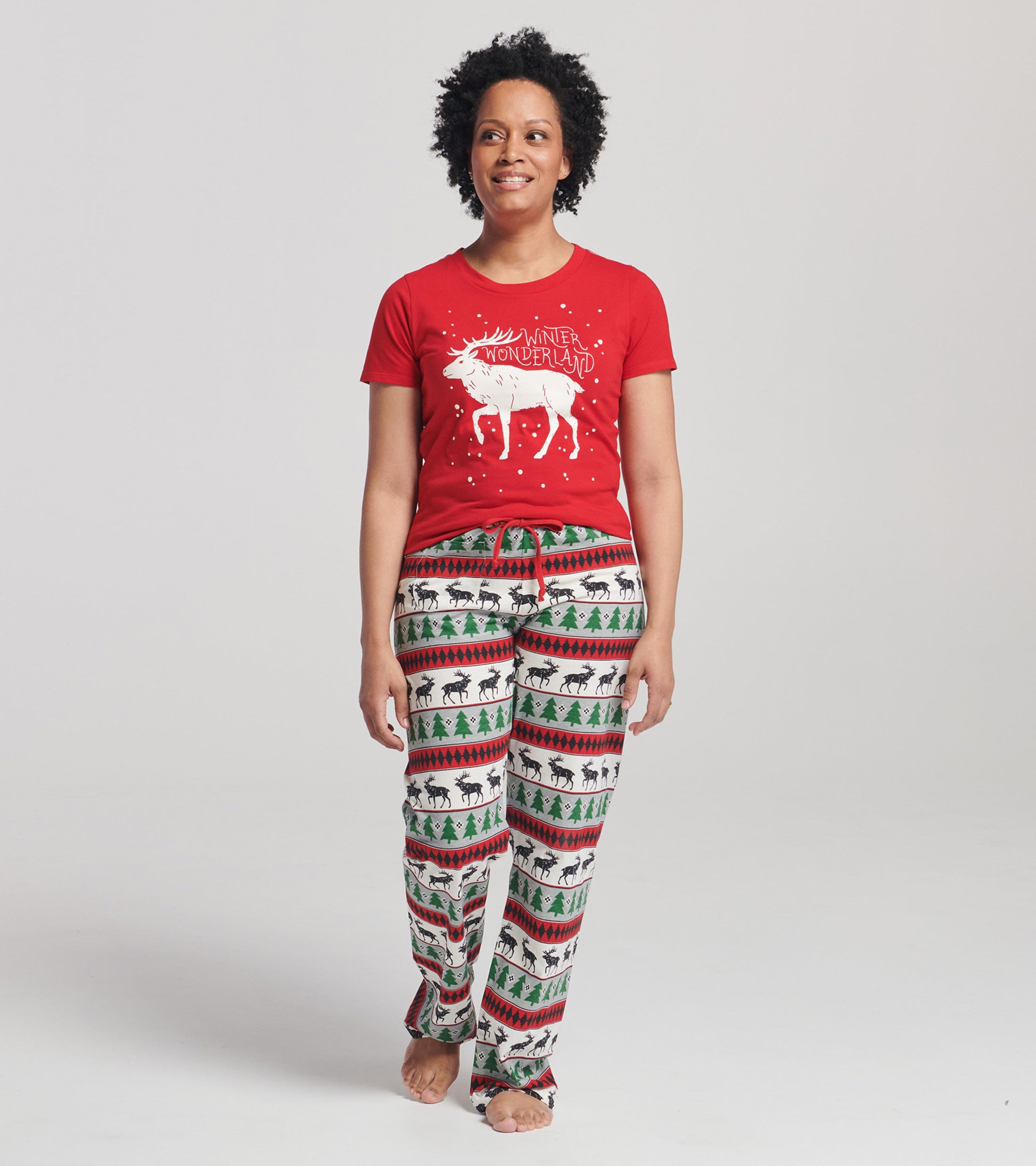 Red short sleeve t-shirt featuring a white winter-themed graphic, paired with patterned pajama pants.