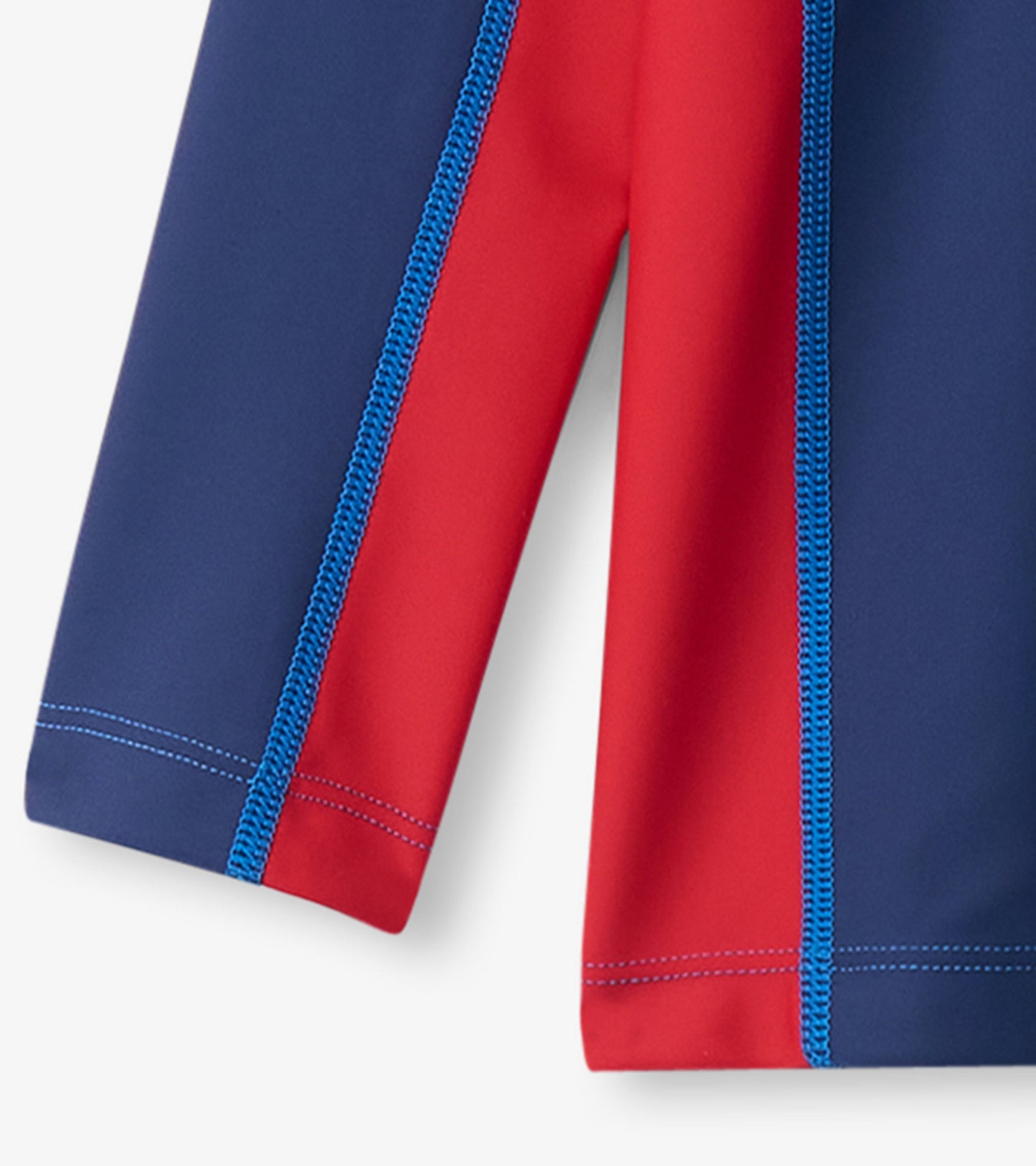 Nautical long sleeve rashguard featuring a colorblock design in navy blue and red with contrasting blue stitching.
