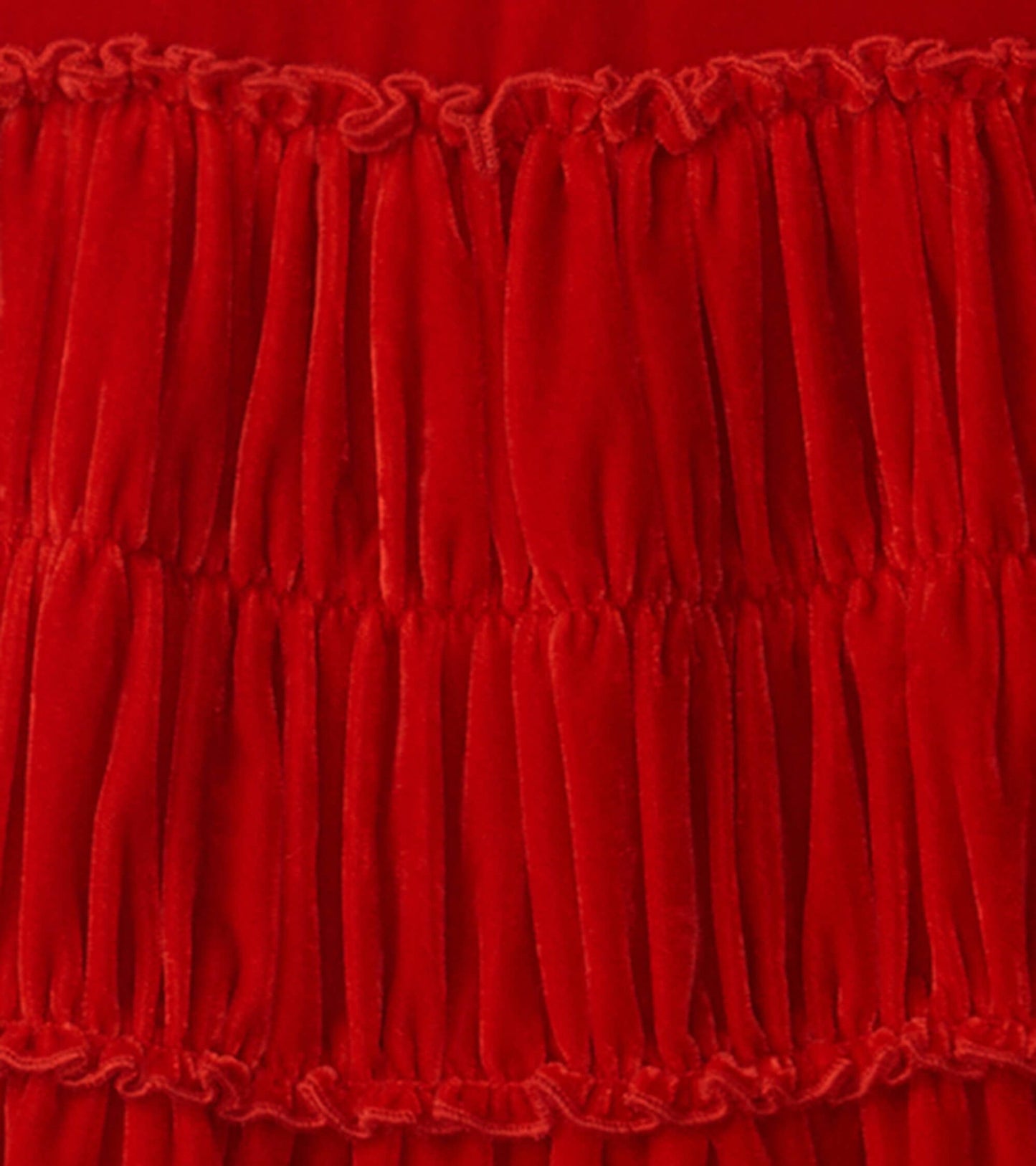 Red velvet dress featuring smocked panels, ideal for special occasions or casual wear.