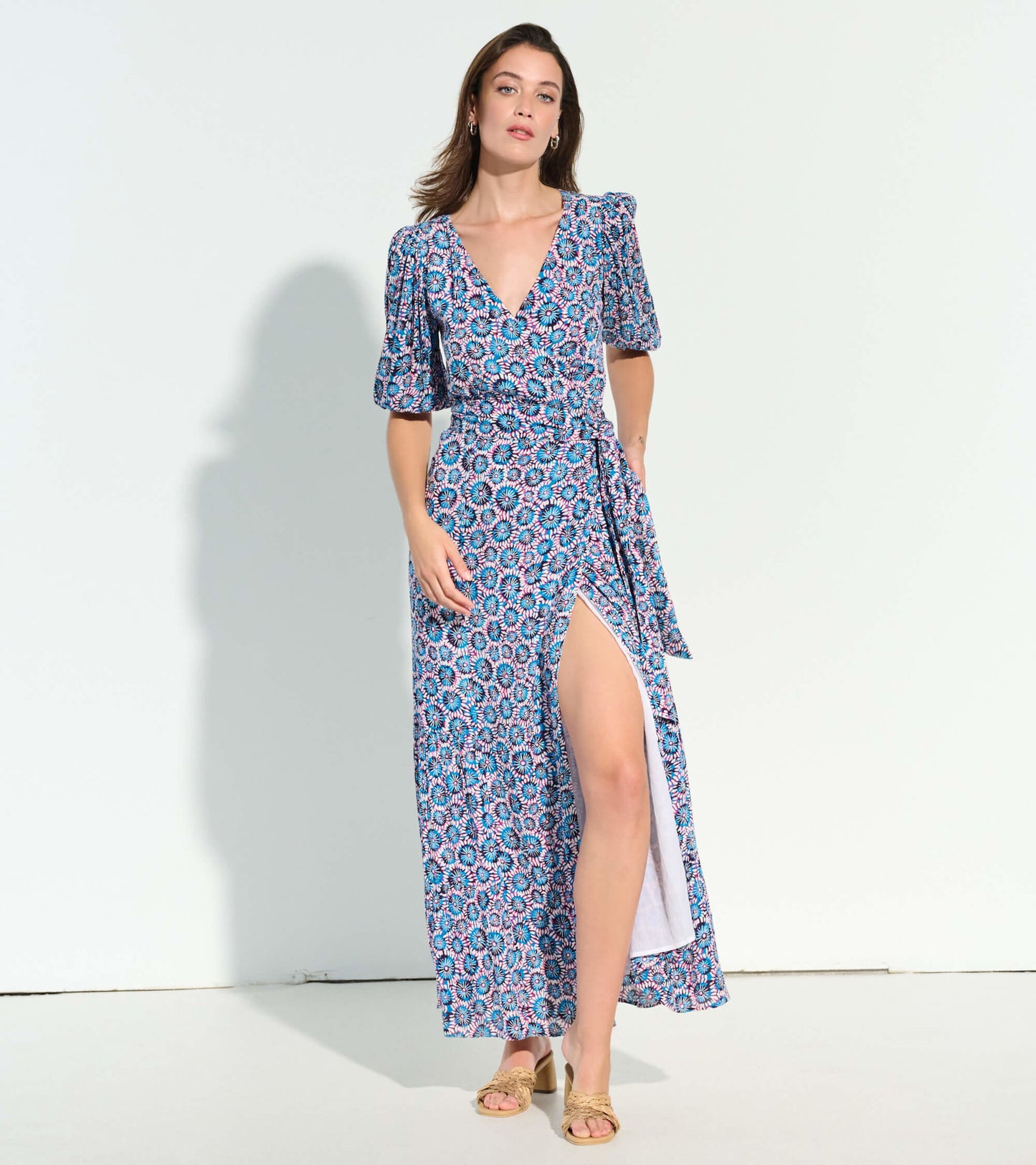 Maxi dress featuring a vibrant sundial mandala pattern, deep V-neck, puff sleeves, and a side slit for a stylish look.