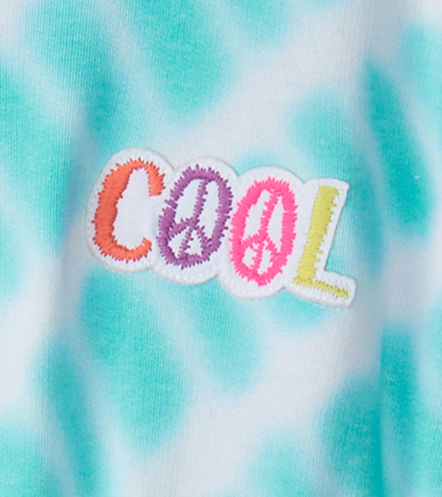 Light blue tie-dye dress featuring a colorful "COOL" embroidered design. Suitable for casual wear.
