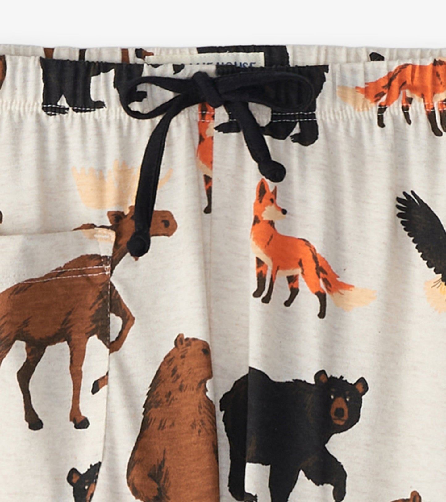 Light beige cotton blend pajama pants featuring a wildlife print with bears, foxes, and moose, elastic waistband with drawst…
