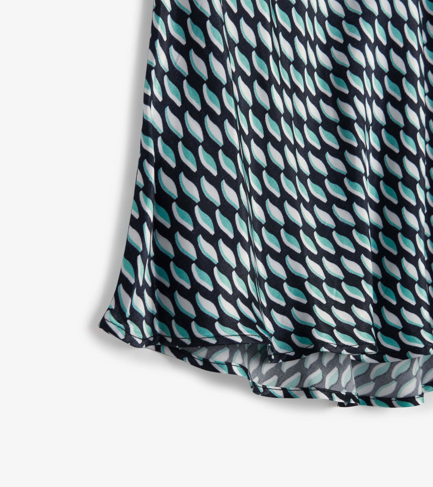 Midi skirt featuring a graphic leaf pattern in teal, white, and navy, with a flowing silhouette and soft fabric.