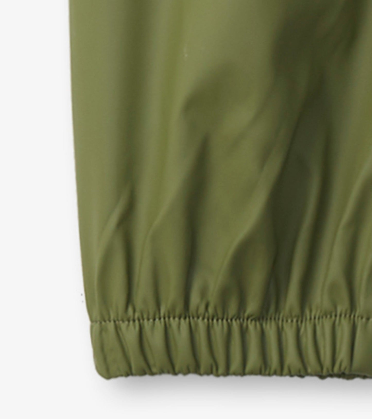 Forest green kids' rain pants with elastic cuffs, made from waterproof material for outdoor play.