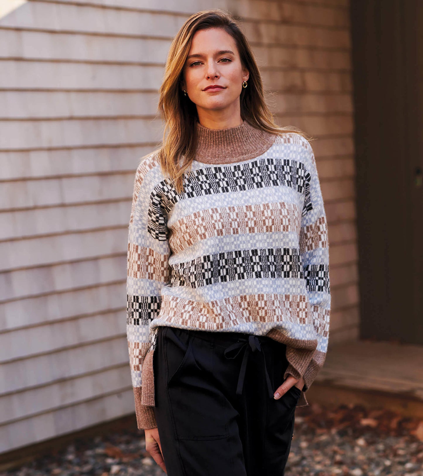 Mock neck sweater featuring a celestial plaid pattern in earthy tones of brown, black, and blue.