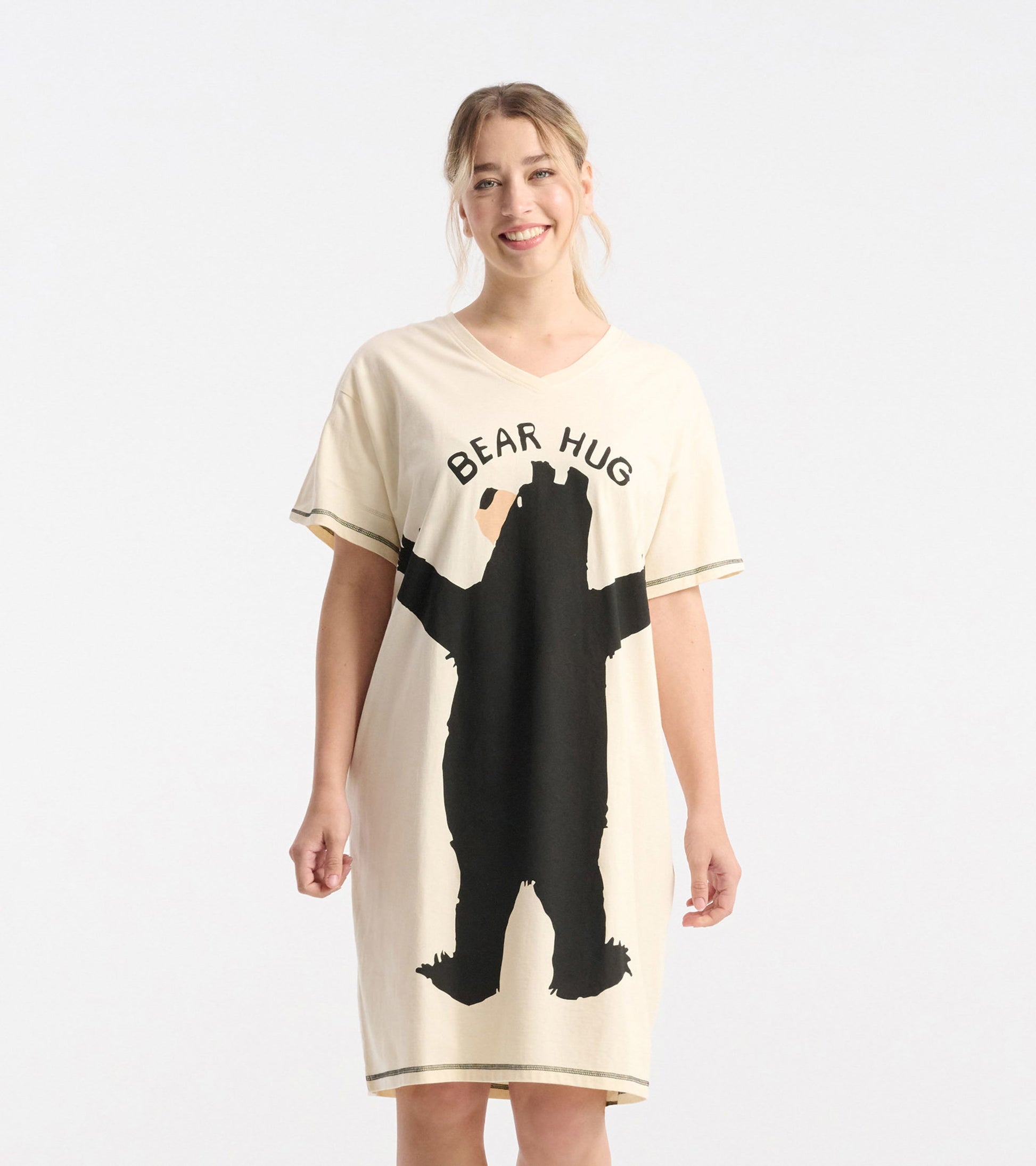 Cream-colored sleepshirt featuring a black bear graphic and "BEAR HUG" text, with short sleeves and a relaxed fit.