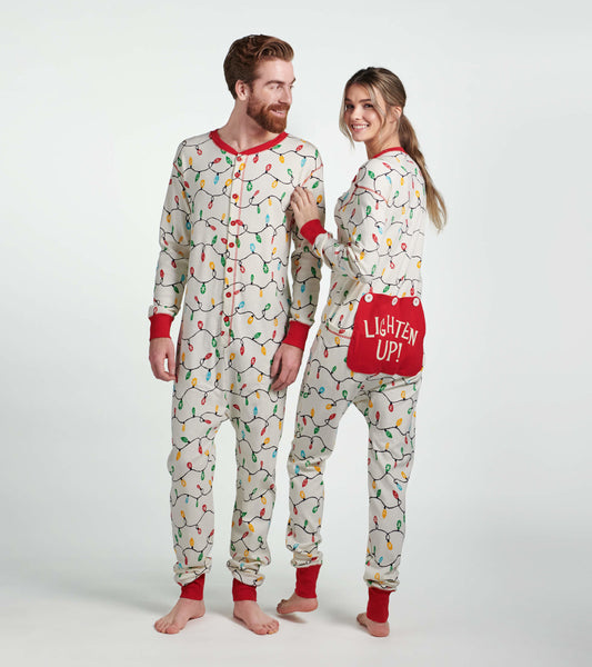 Adult onesie featuring a festive holiday lights pattern, red cuffs, and a back pocket with "LIGHTEN UP!" text.