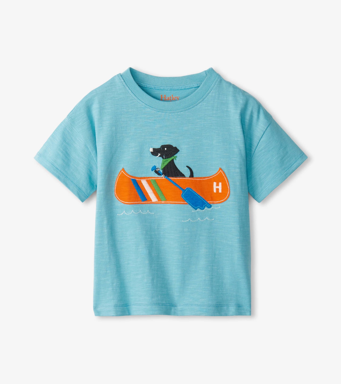 Light blue short-sleeve tee featuring a graphic of a dog in a canoe with colorful stripes and a paddle.