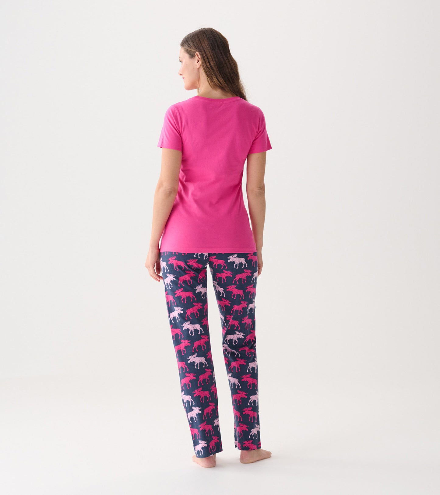 Pink short-sleeve pajama t-shirt paired with patterned pants featuring moose in pink and white on a navy background.