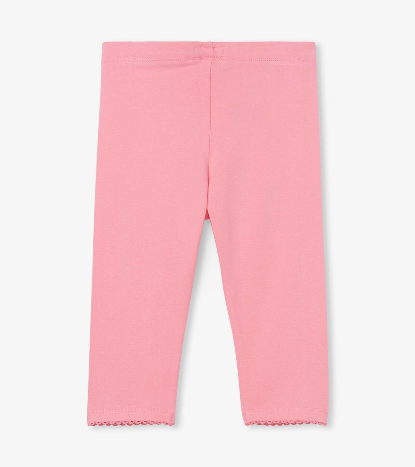 Light pink leggings with a soft fabric and scalloped hem, suitable for casual wear.