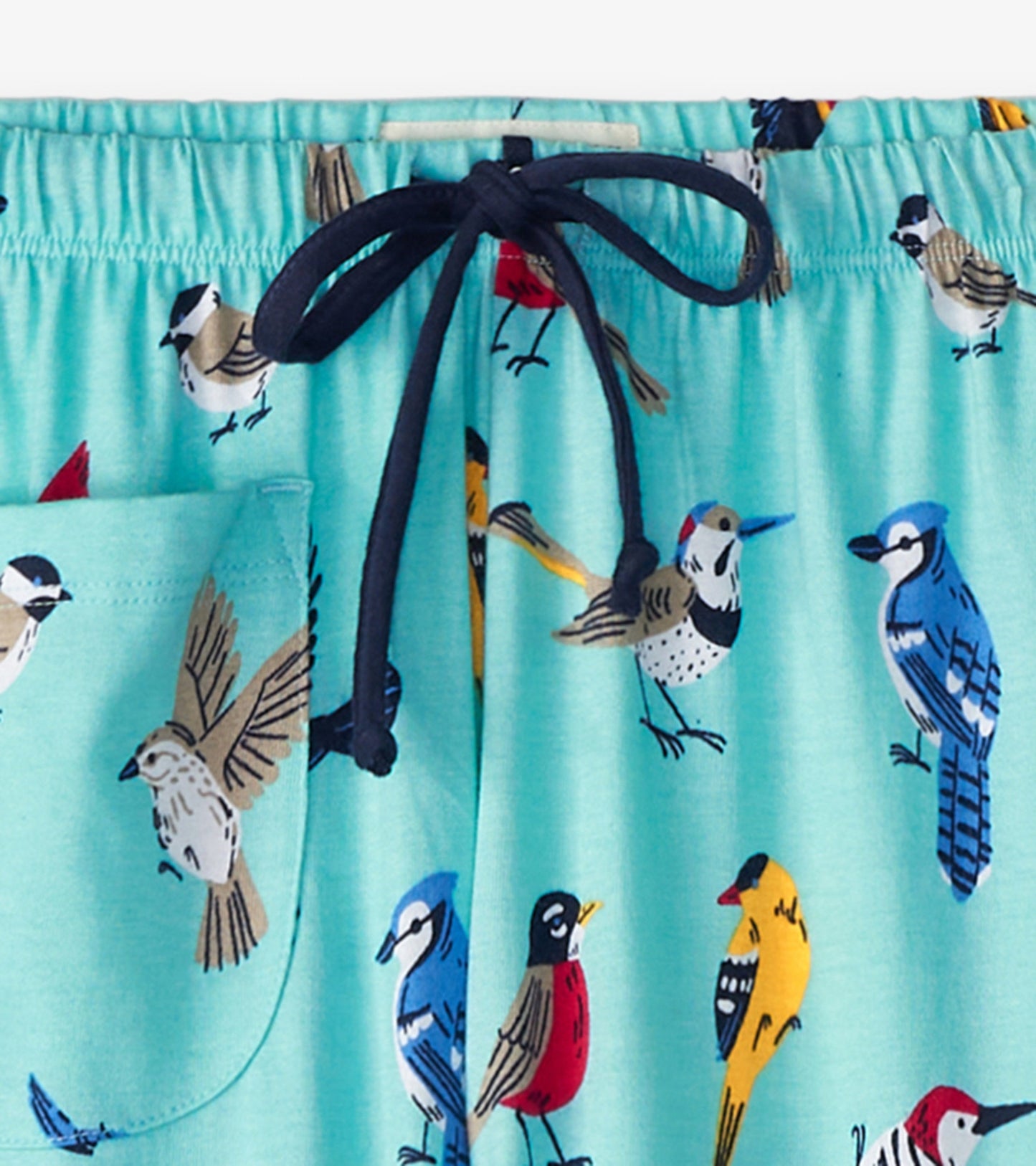 Light blue cotton pajama pants featuring a colorful bird print and a drawstring waistband with a side pocket.