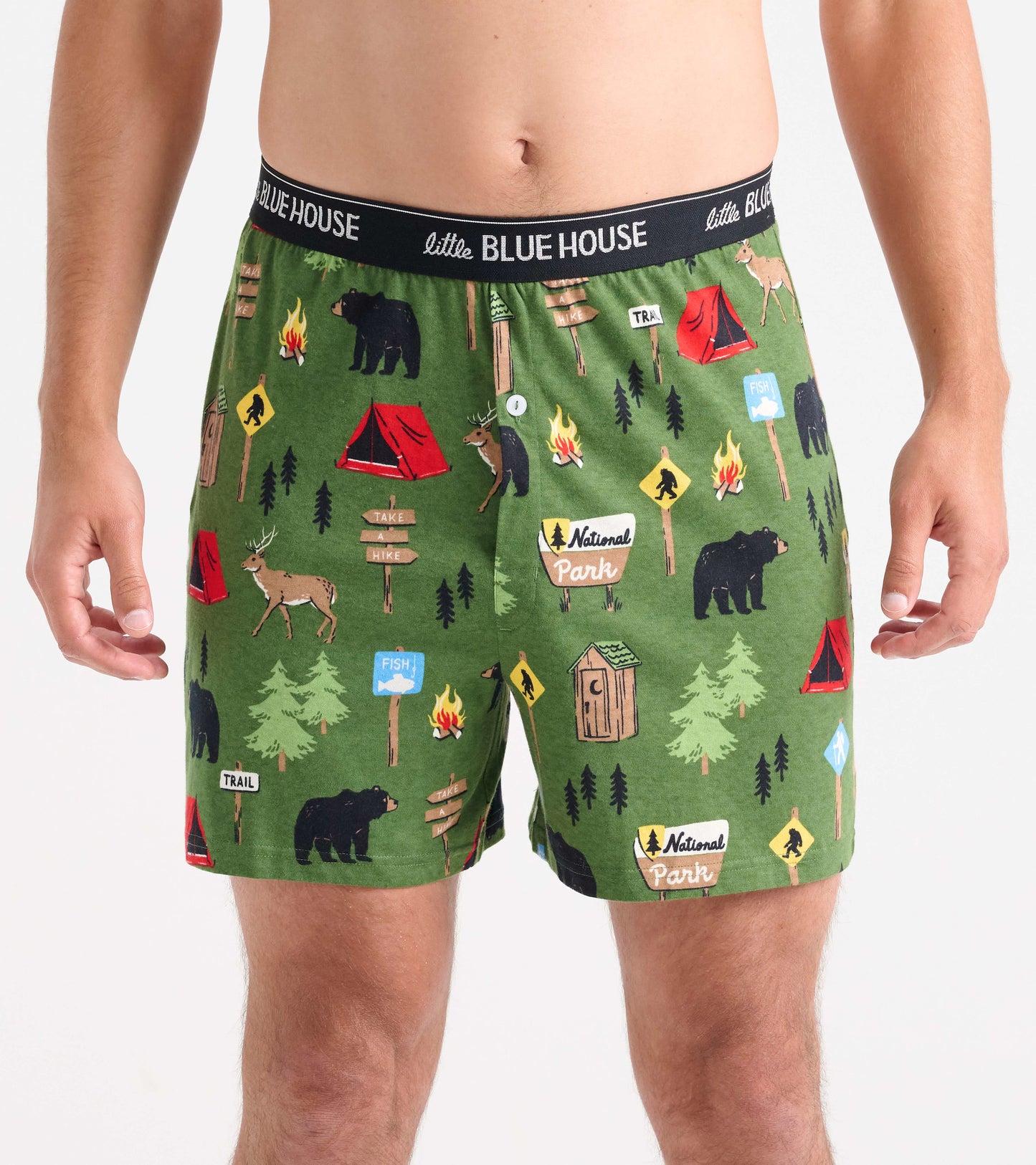Green boxer shorts featuring a camping and wildlife pattern with bears, tents, and trees. Elastic waistband visible.