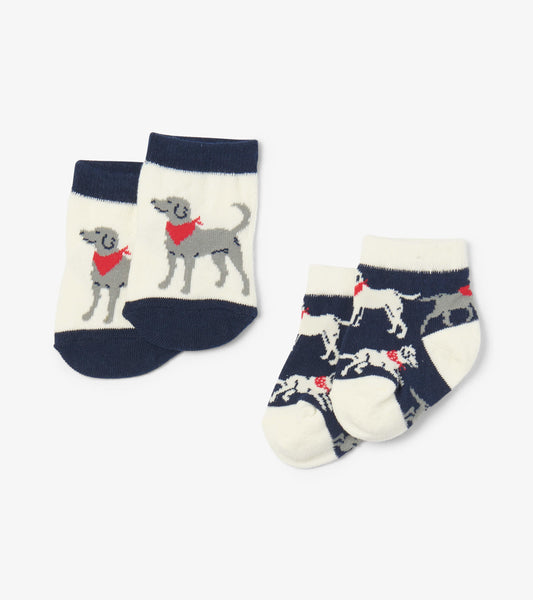 Navy and cream baby socks featuring playful dog designs, perfect for infants aged 0-24 months.