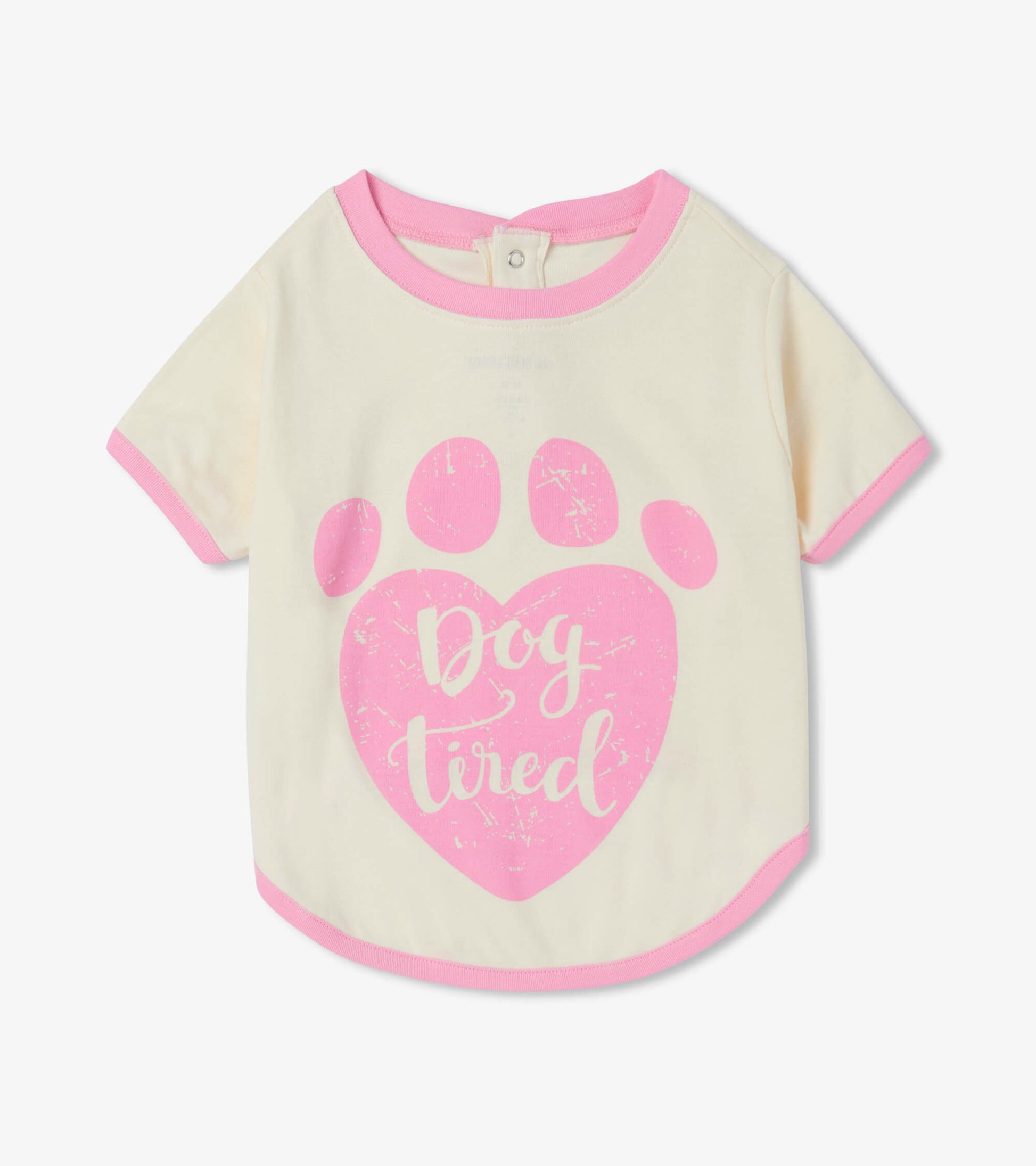 Cream dog tee with pink trim featuring a paw print and "Dog tired" text in a playful font.