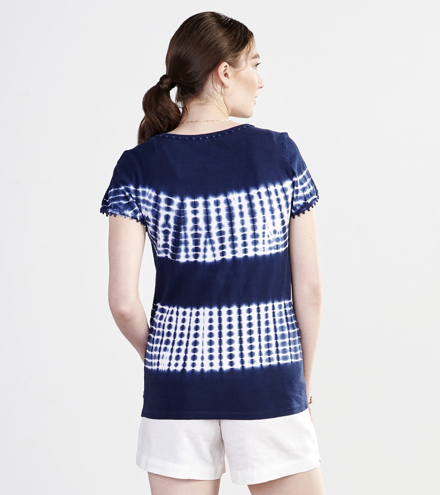 Navy blue tie-dye tee with white patterns and scalloped sleeves, shown from the back.