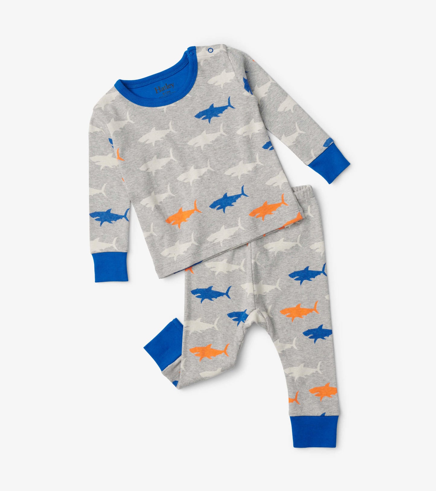 Gray baby pajama set featuring colorful shark patterns, with long sleeves and pants, accented by blue cuffs.
