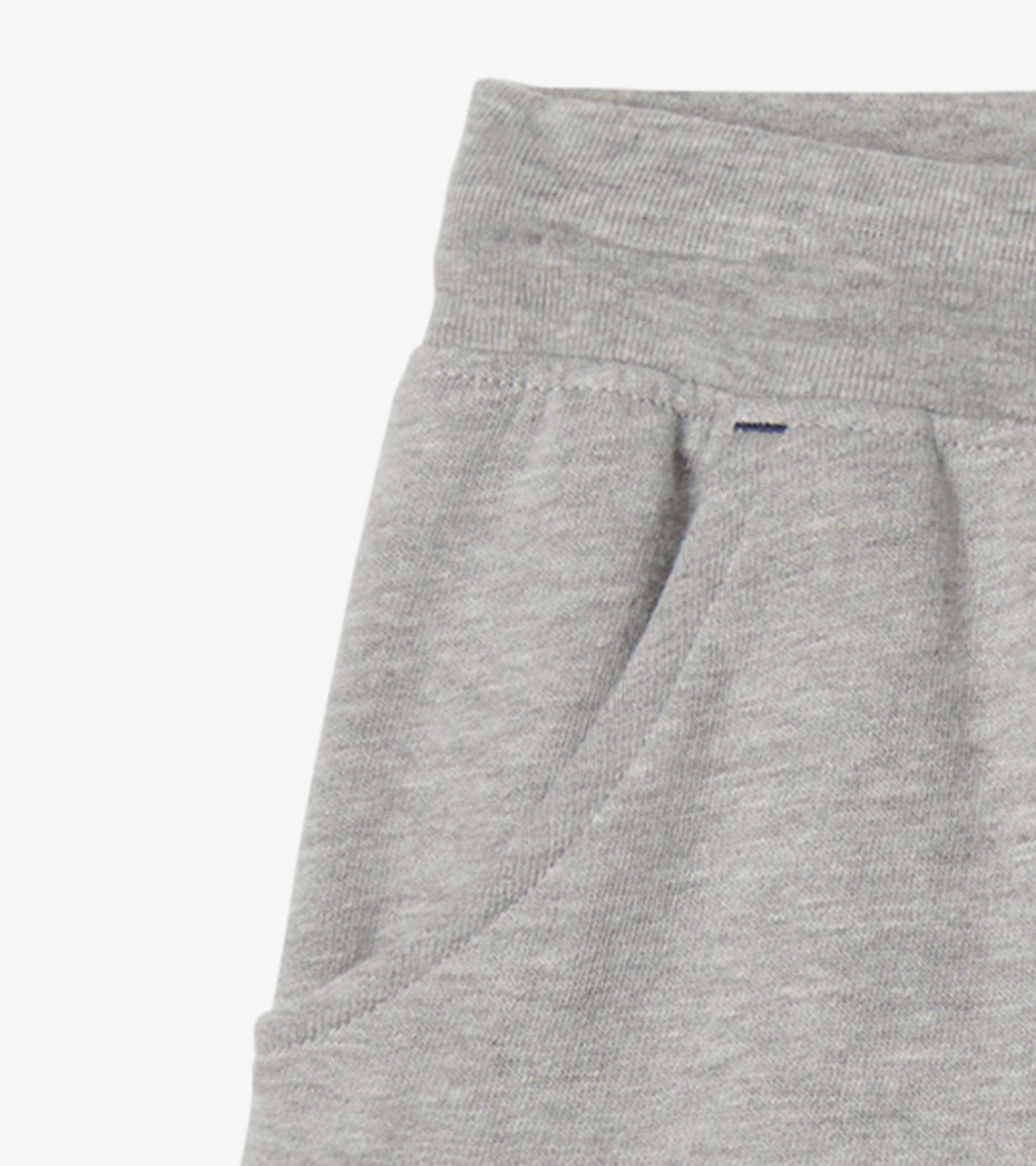 Grey terry shorts with an elastic waistband and side pockets, suitable for athletic activities.