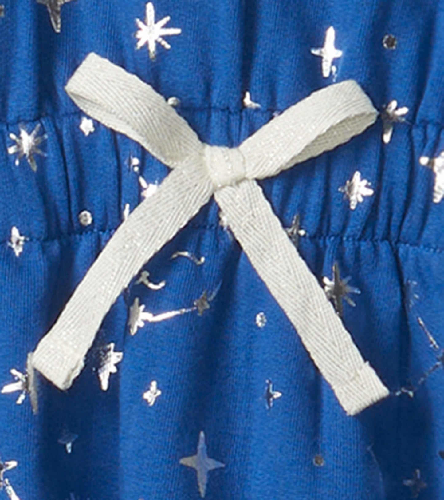 Blue terry dress featuring silver star constellations and a white bow at the waist.