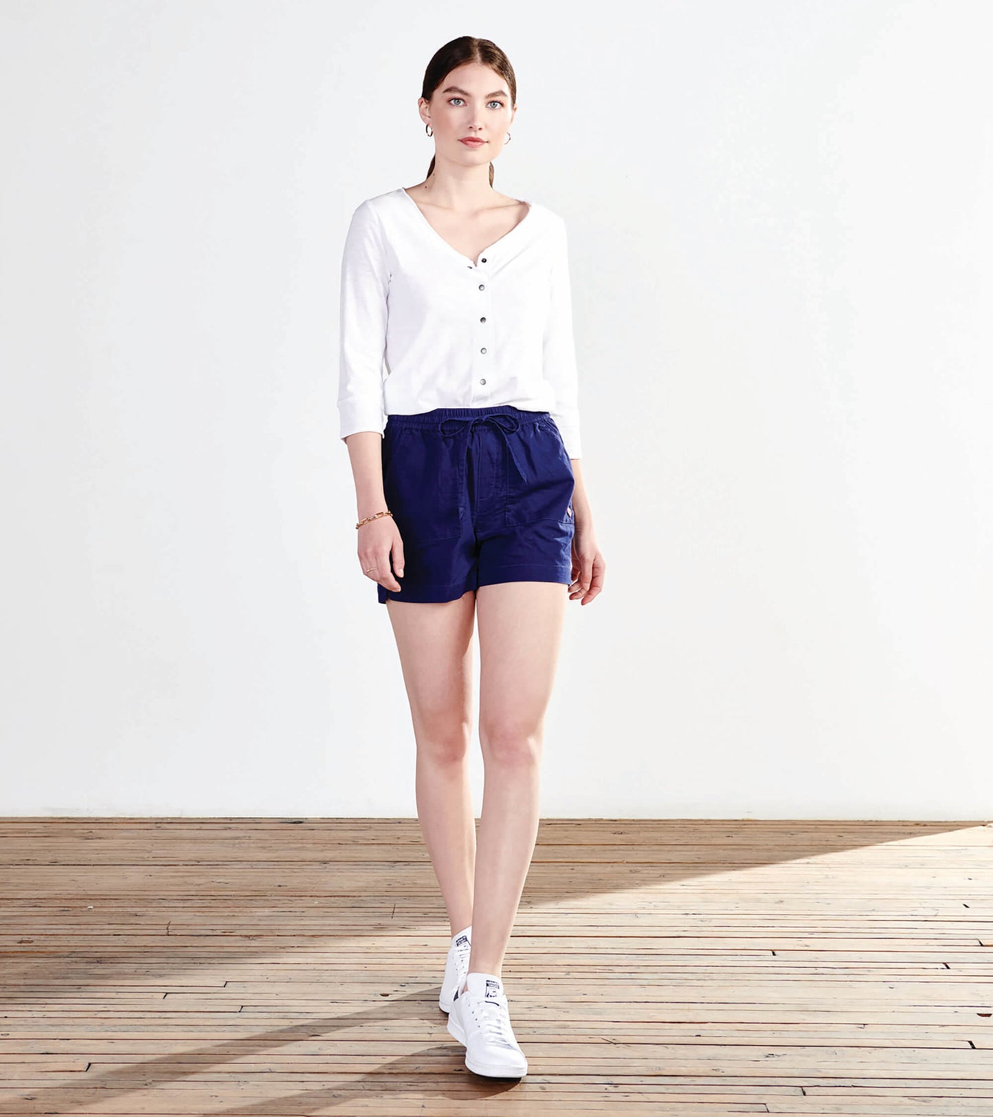 Patriot blue shorts with an elastic waistband and drawstring, paired with a white button-up top and white sneakers.