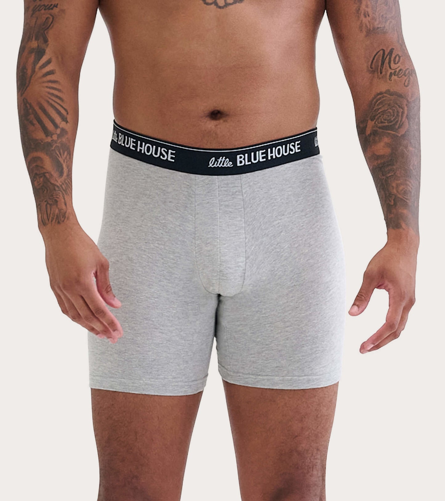 Gray boxer briefs with a black waistband, featuring a snug fit and soft fabric, modeled on a person.