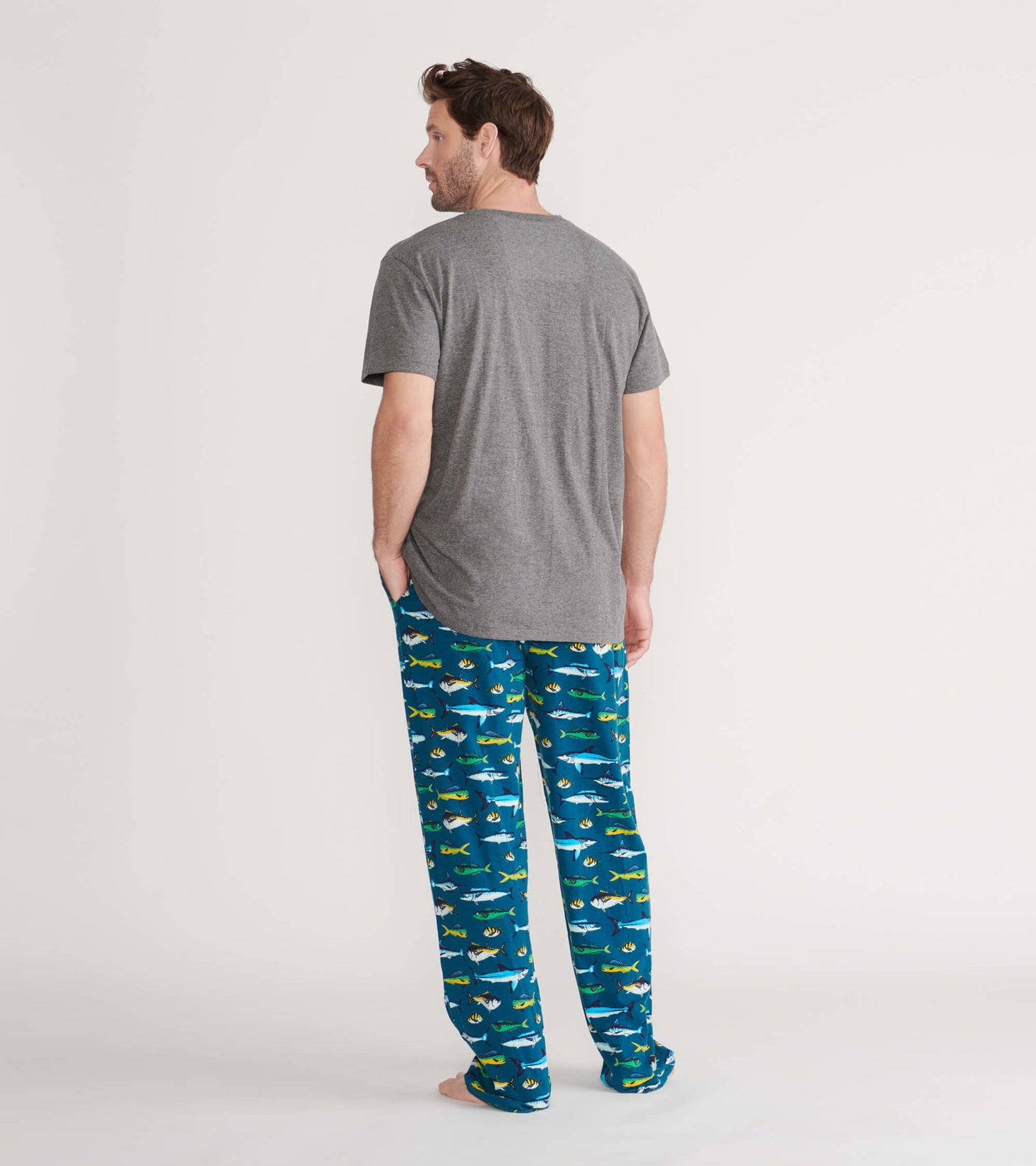 Gray short-sleeve tee worn with colorful fish-patterned pajama pants, viewed from the back.