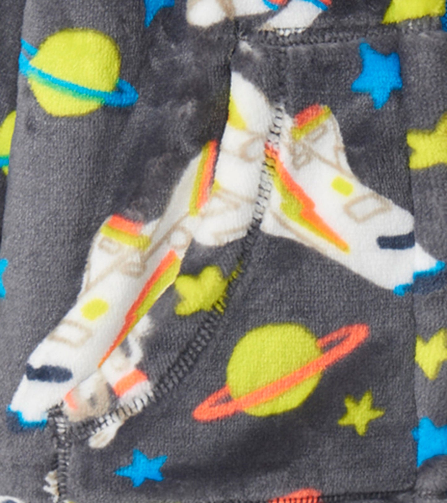Gray fleece jacket featuring colorful astronaut, rocket, planet, and star patterns. Ideal for kids' casual wear.