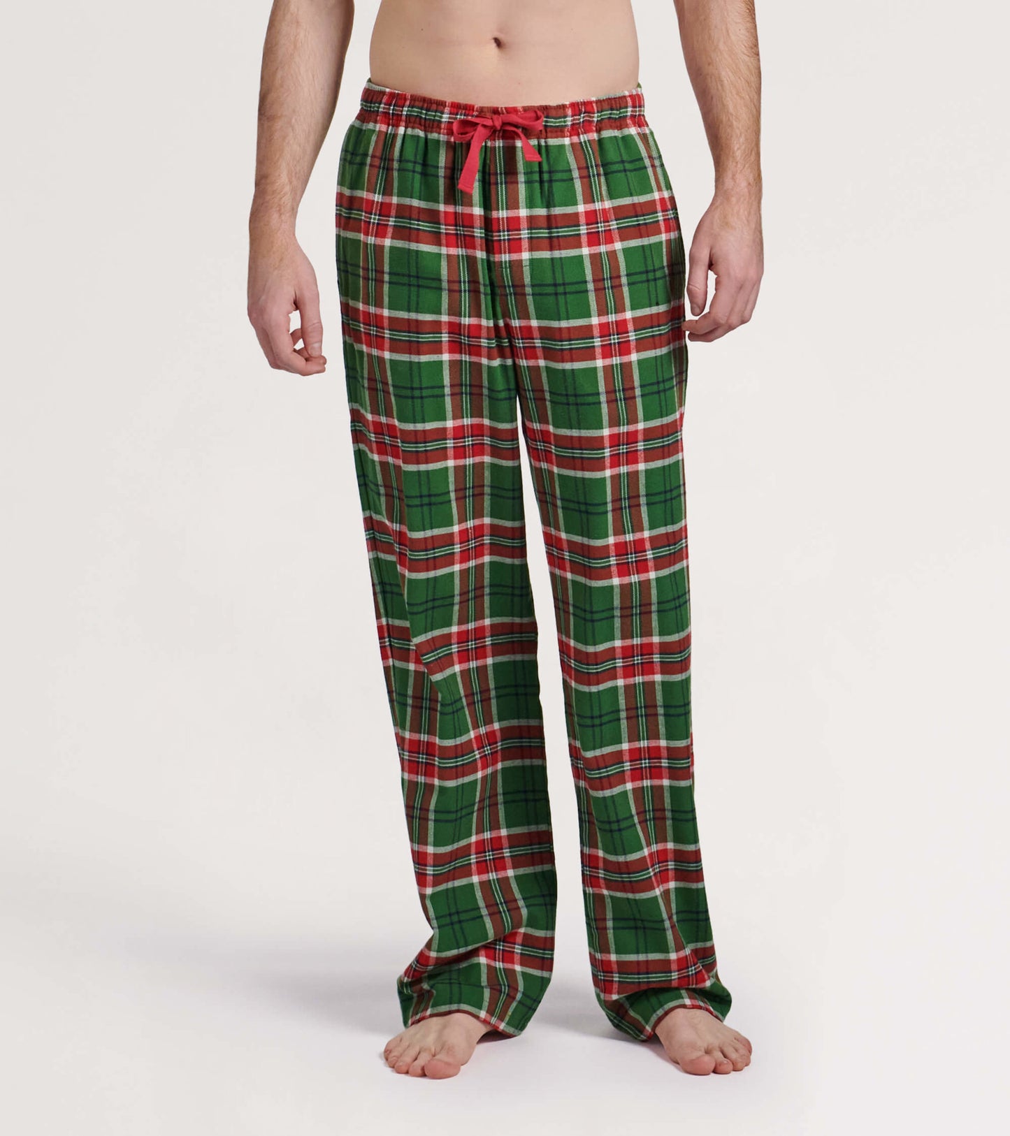 Green flannel pajama pants with a red and white plaid pattern, featuring an elastic waistband and drawstring.