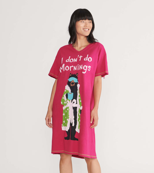 Pink women's sleepshirt featuring a bear graphic in a robe with the text "I don't do Mornings." Short sleeves and relaxed fi…