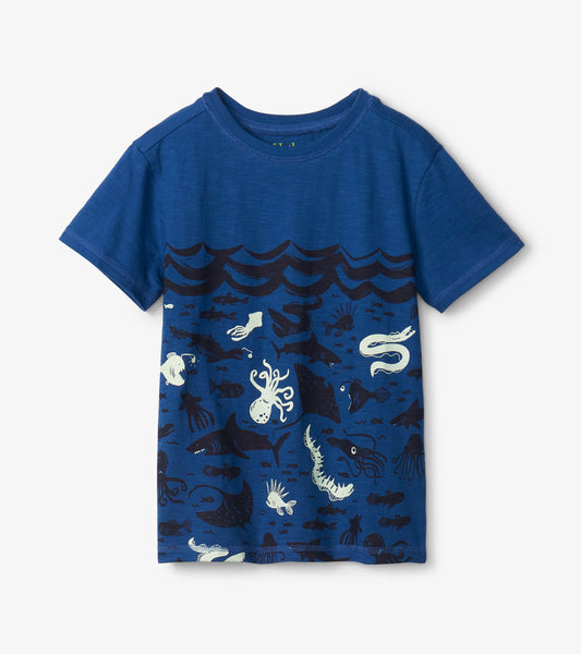 Blue graphic tee featuring ocean-themed designs with sea creatures and waves, suitable for casual wear.