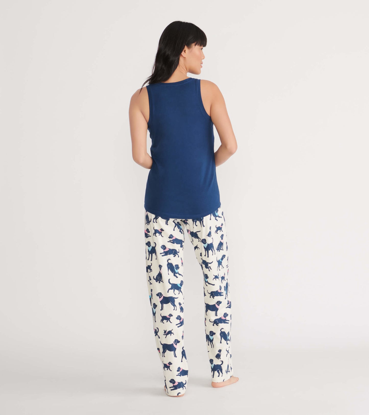 Navy tank top paired with white pajama pants featuring playful dog prints, shown from the back.