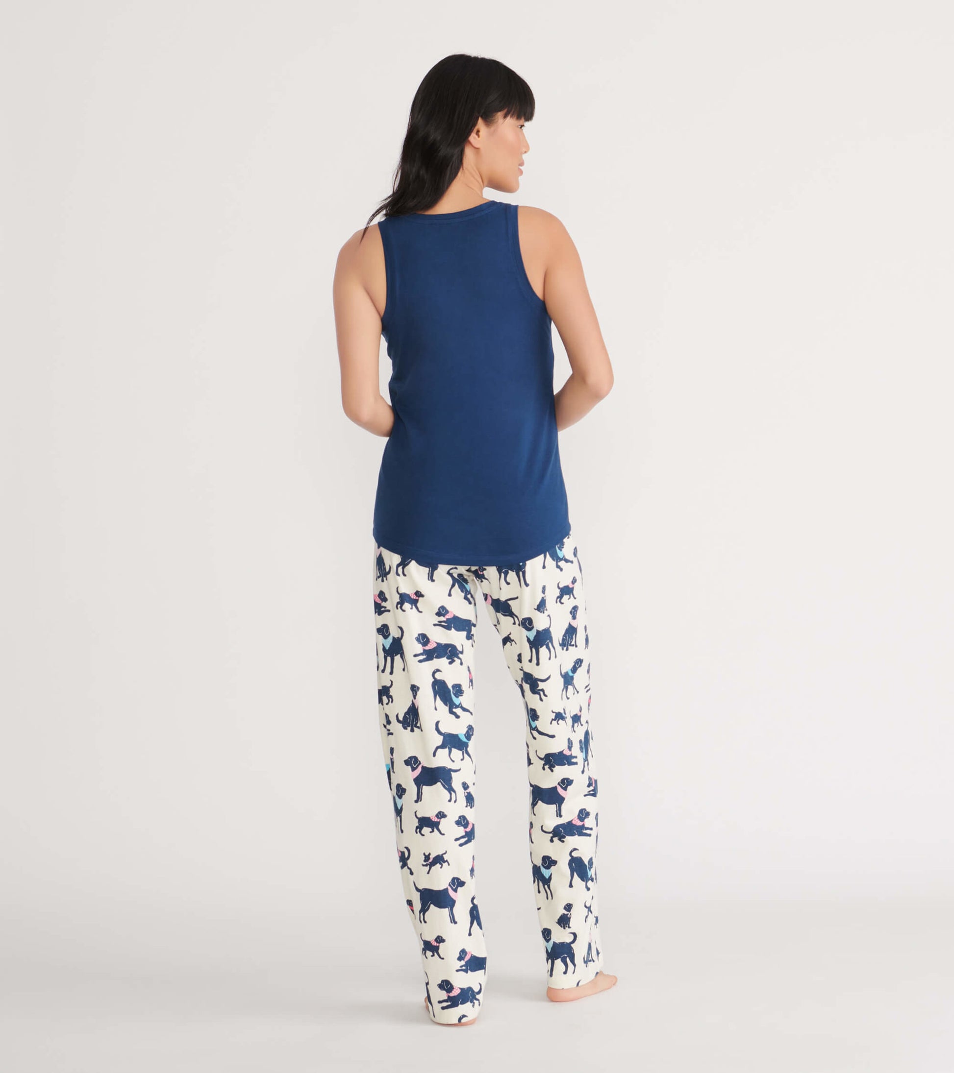 Navy tank top paired with white pajama pants featuring playful dog prints, shown from the back.