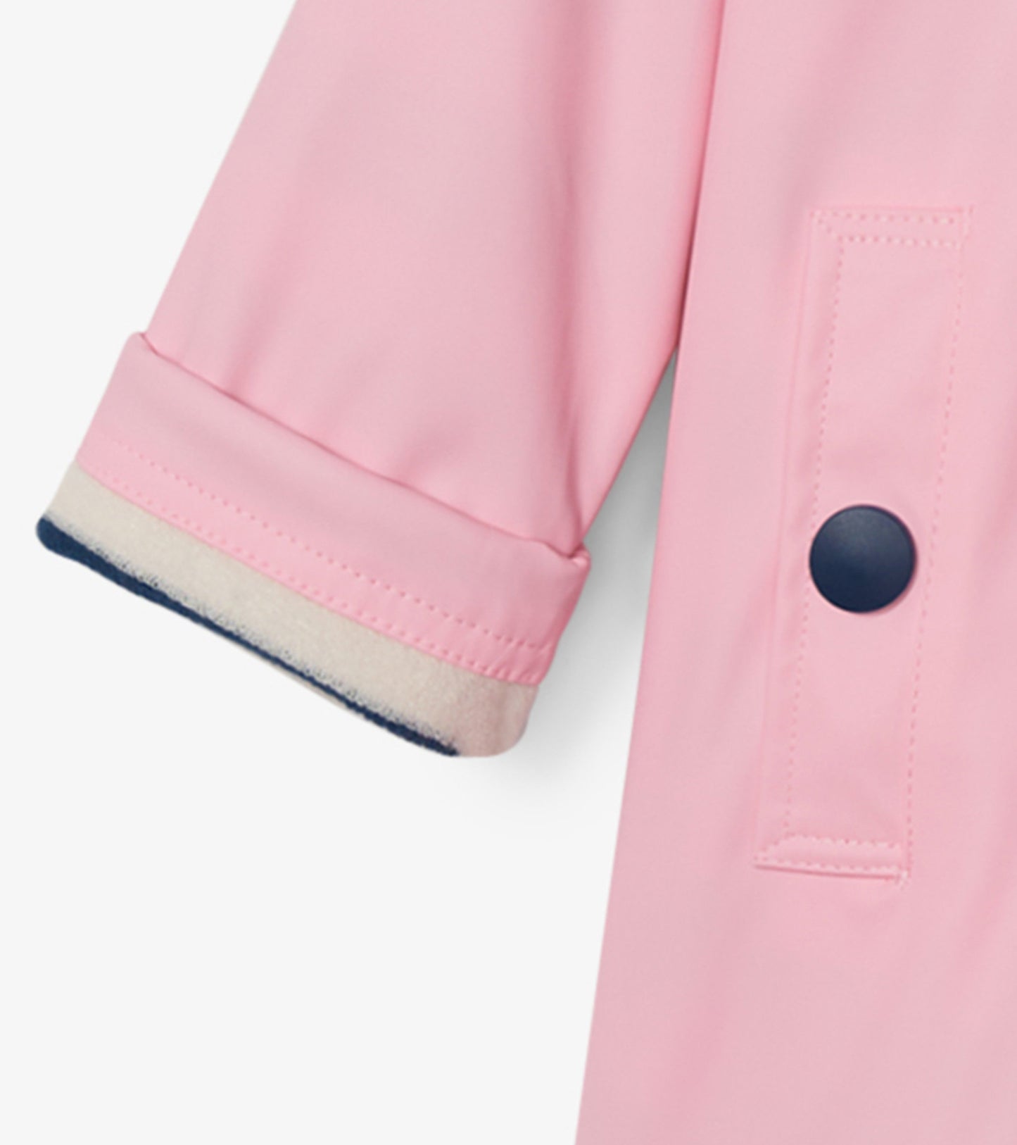 Pink button-up rain jacket with navy trim and rolled sleeves, designed for girls.