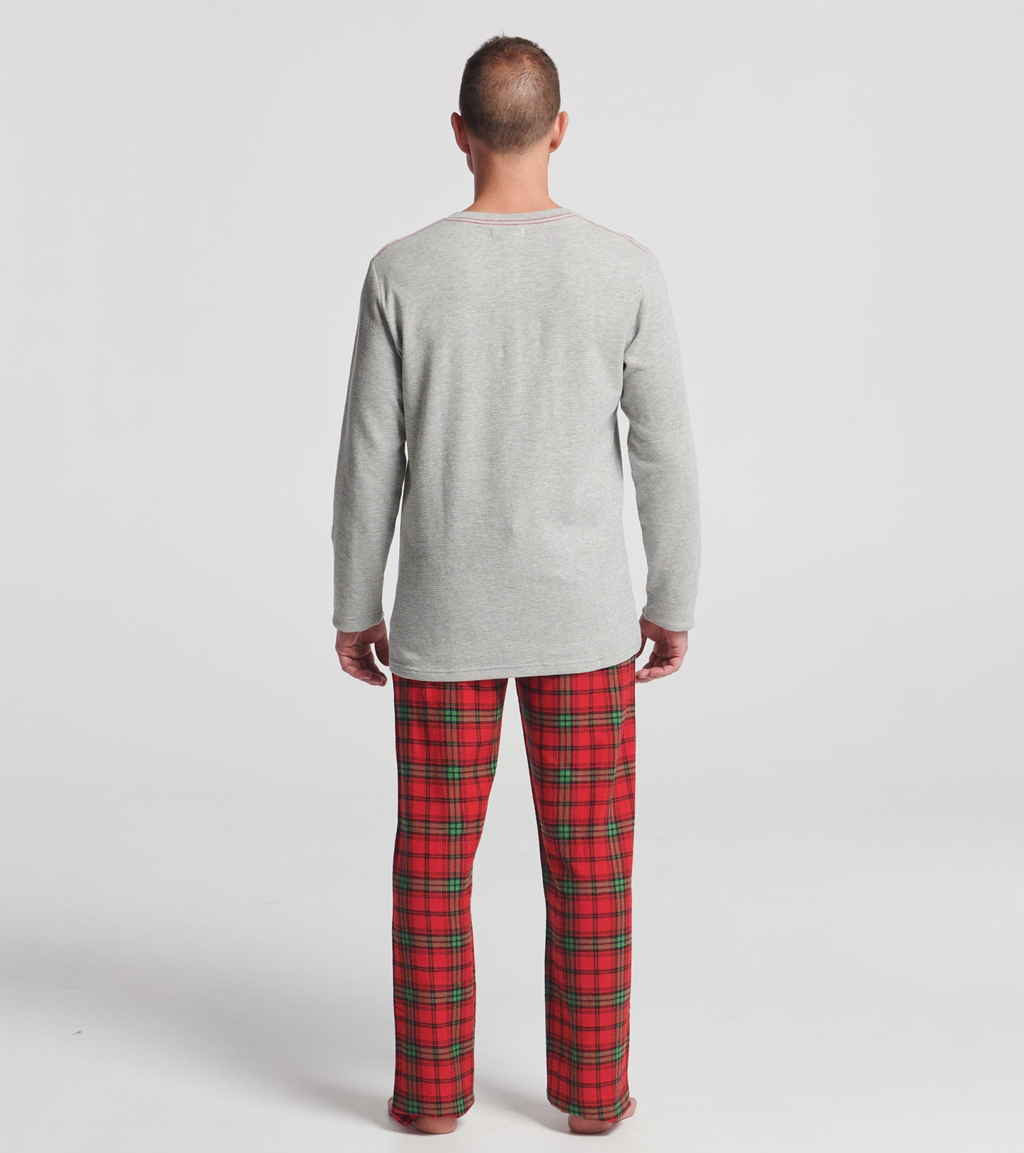 Men's flannel pajama pants in red and green plaid pattern, relaxed fit, perfect for holiday lounging.