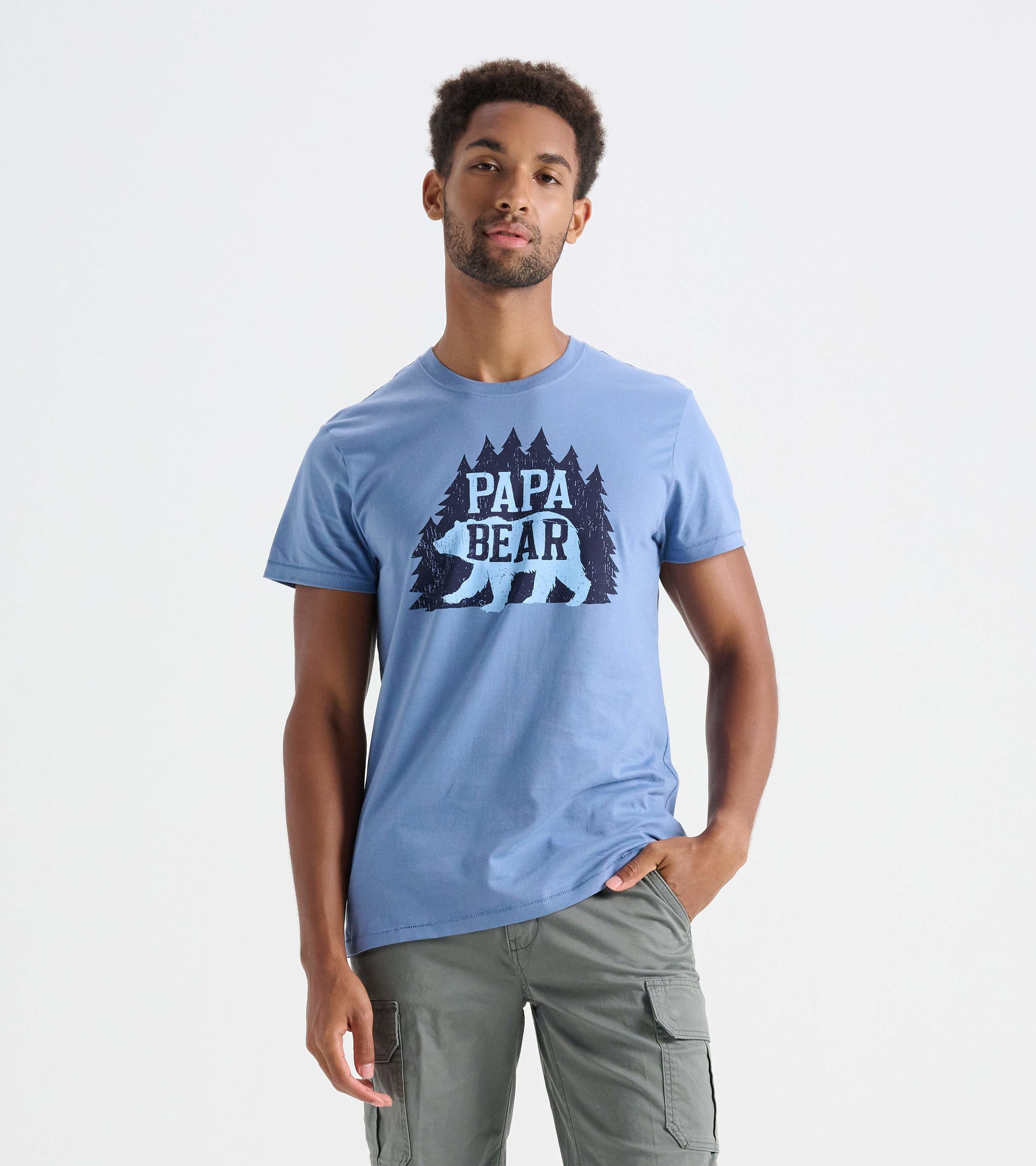 Light blue men's t-shirt featuring a bear and tree graphic design on the front. Casual fit with short sleeves.
