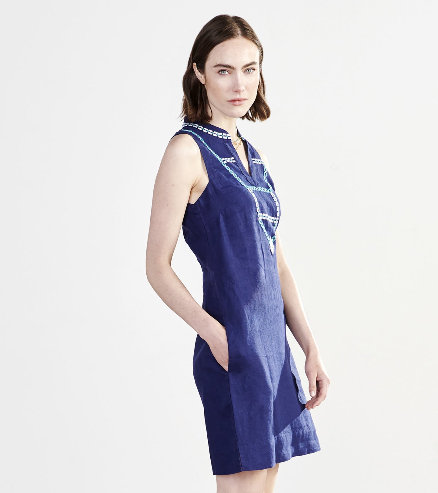 Patriot blue sleeveless shift dress with a V-neck and decorative stitching, featuring side pockets.