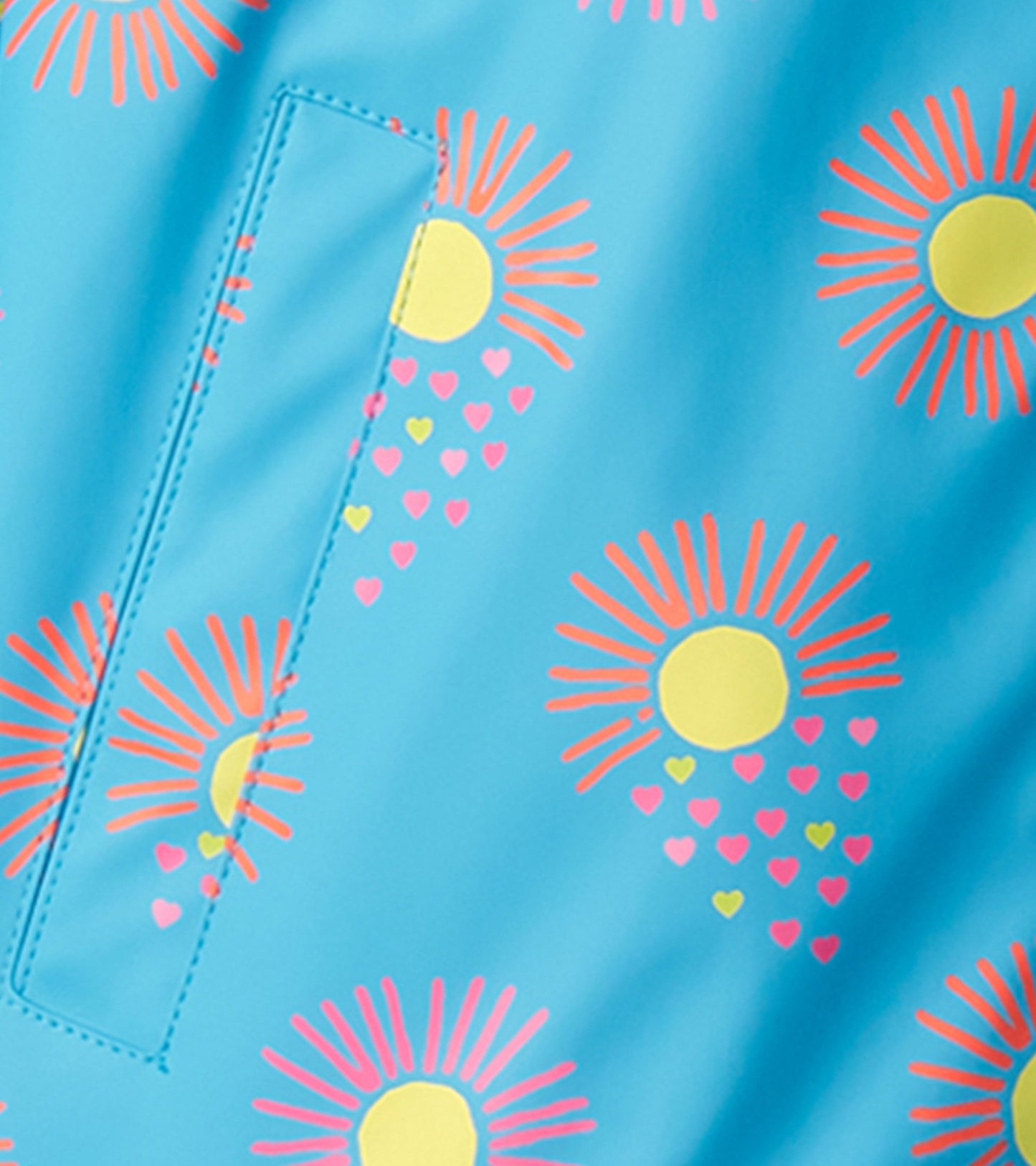 Light blue rain jacket featuring colorful sun and heart patterns, with a zip-up front and pocket detail.